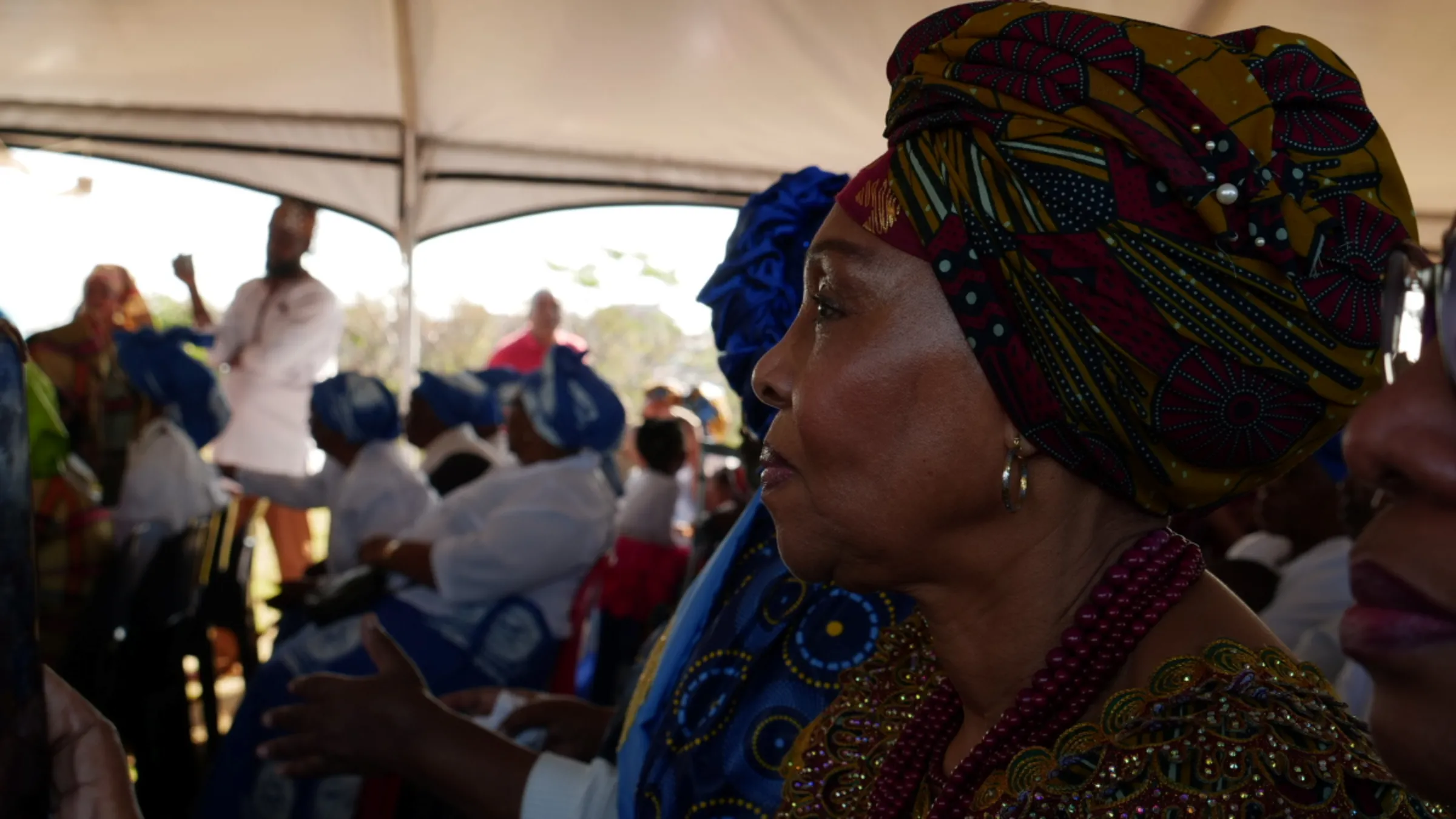 Catherine Salim looks on at the performances of a cultural event celebrating her ancestors’ freedom from slavery 150 years prior in Chatsworth, Durban, South Africa, August 6, 2023. Thomson Reuters Foundation/Kim Harrisberg