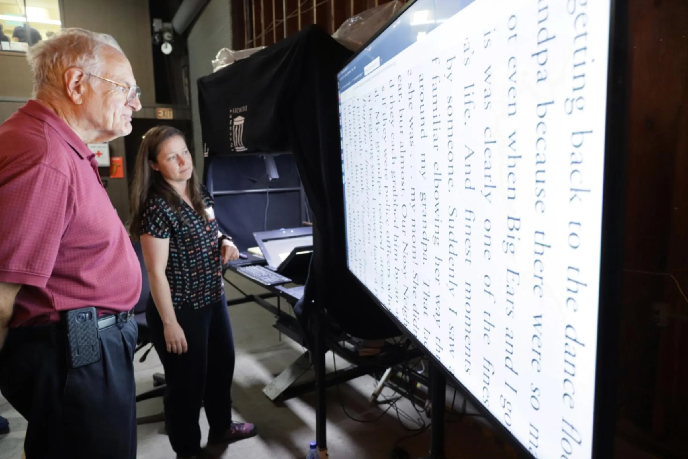 An employee shows off an image captured from digitization equipment at the Internet Archive’s physical archive in Richmond, California, in October 2023. Brad Shirakawa/Handout via Thomson Reuters Foundation