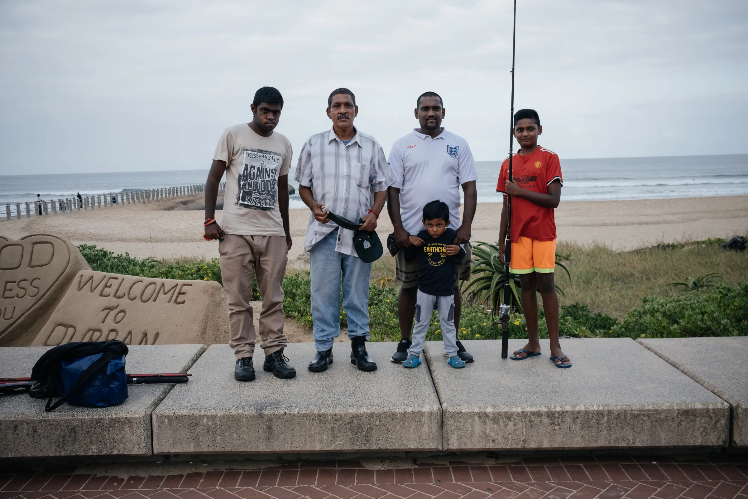 Subsistence anglers look for a catch at Snakepark Pier on the beachfront in Durban, South Africa, April 1, 2021. They fear warming oceans, sea level rise and decreases in the diversity of fish species will hit their catch. Thomson Reuters Foundation/James Puttick