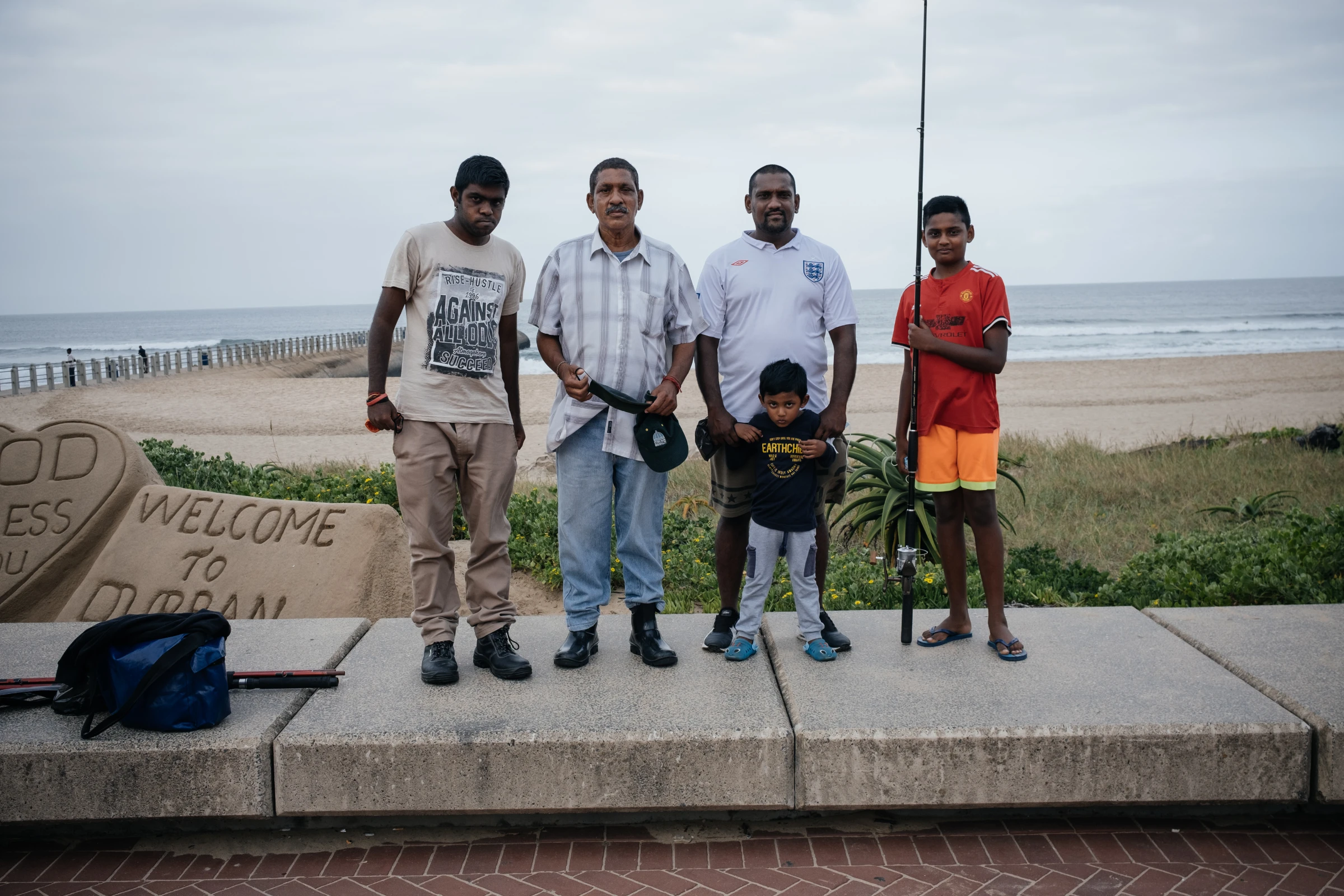 Subsistence anglers look for a catch at Snakepark Pier on the beachfront in Durban, South Africa, April 1, 2021. They fear warming oceans, sea level rise and decreases in the diversity of fish species will hit their catch. Thomson Reuters Foundation/James Puttick