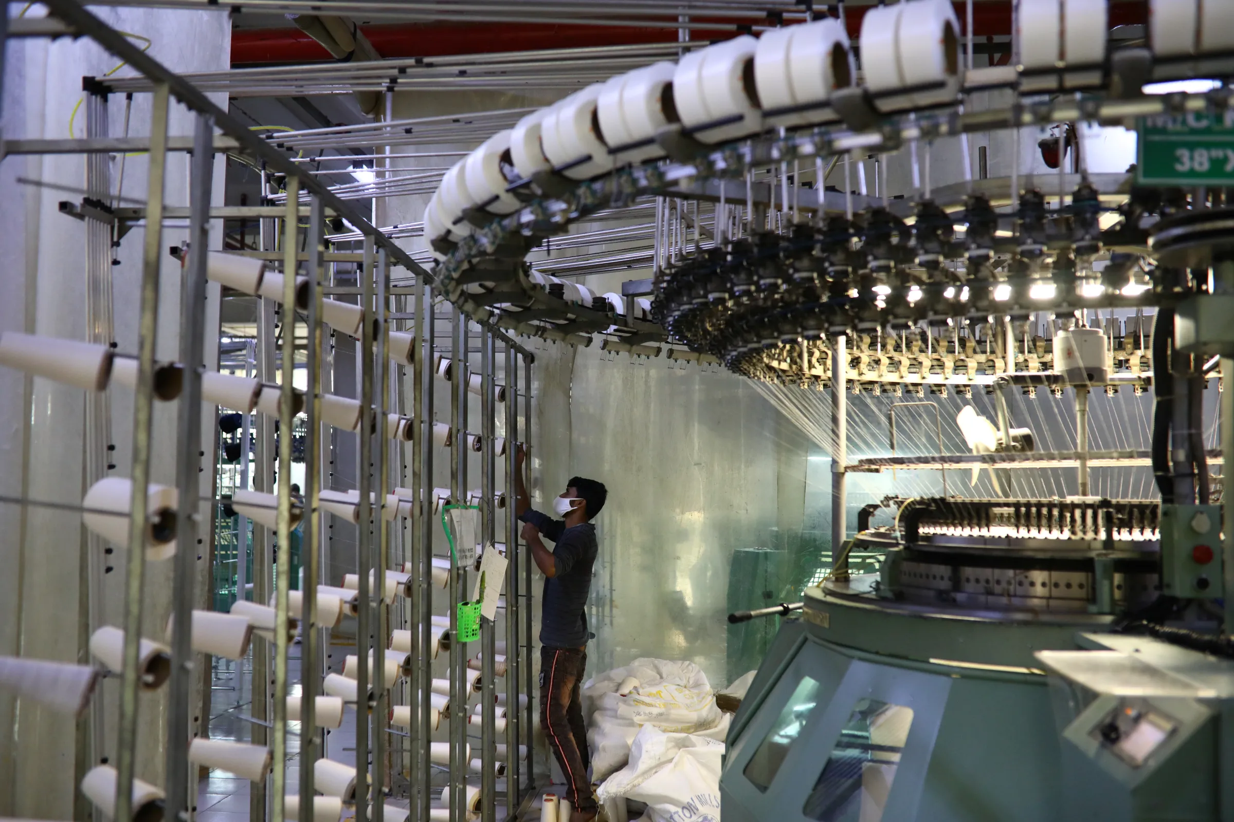 An employee works in a knitting section of the Fakhruddin Textile Mills Limited in Gazipur, Bangladesh, February 7, 2021.  REUTERS/Mohammad Ponir Hossain