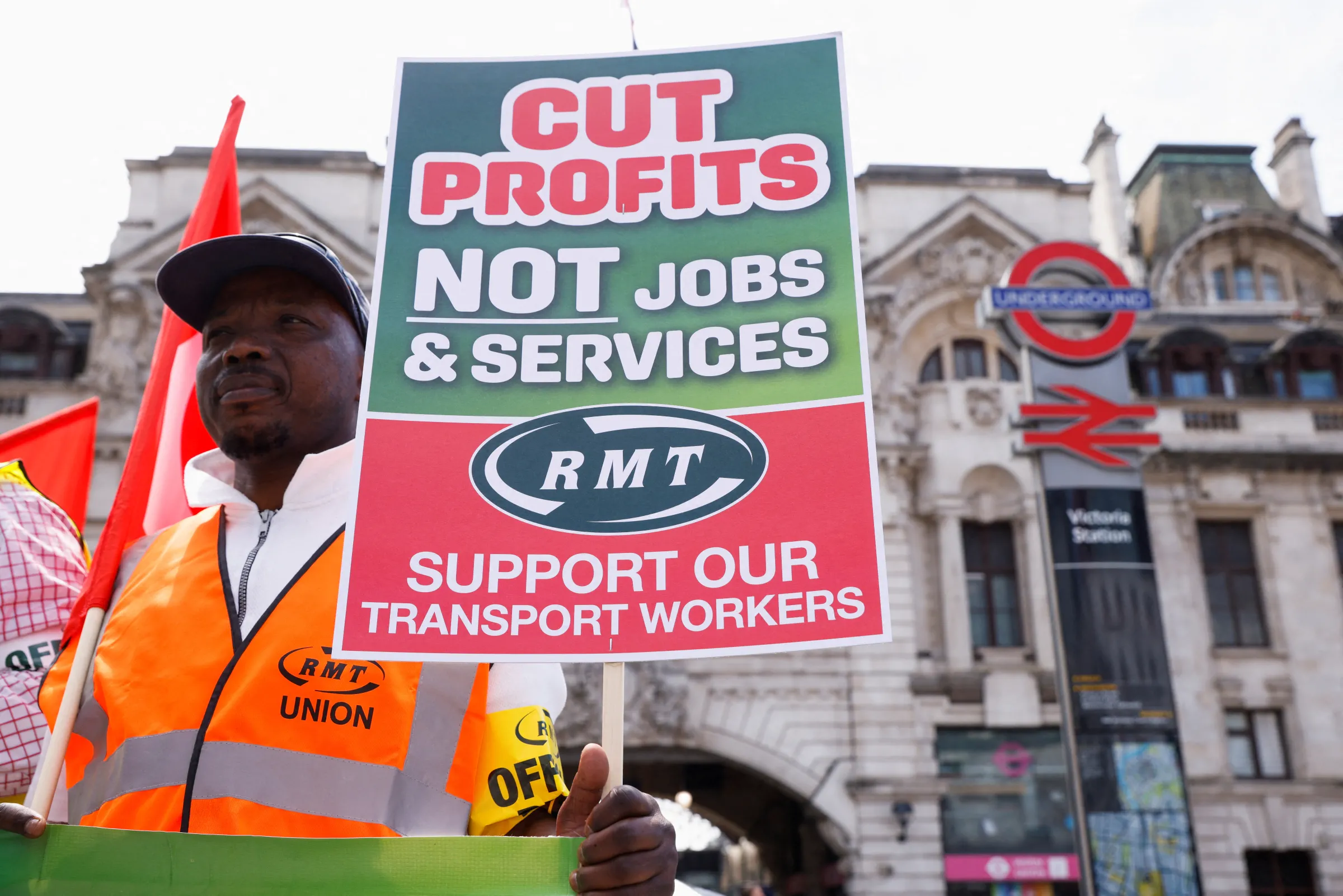 An RMT union member pickets outside Victoria Station