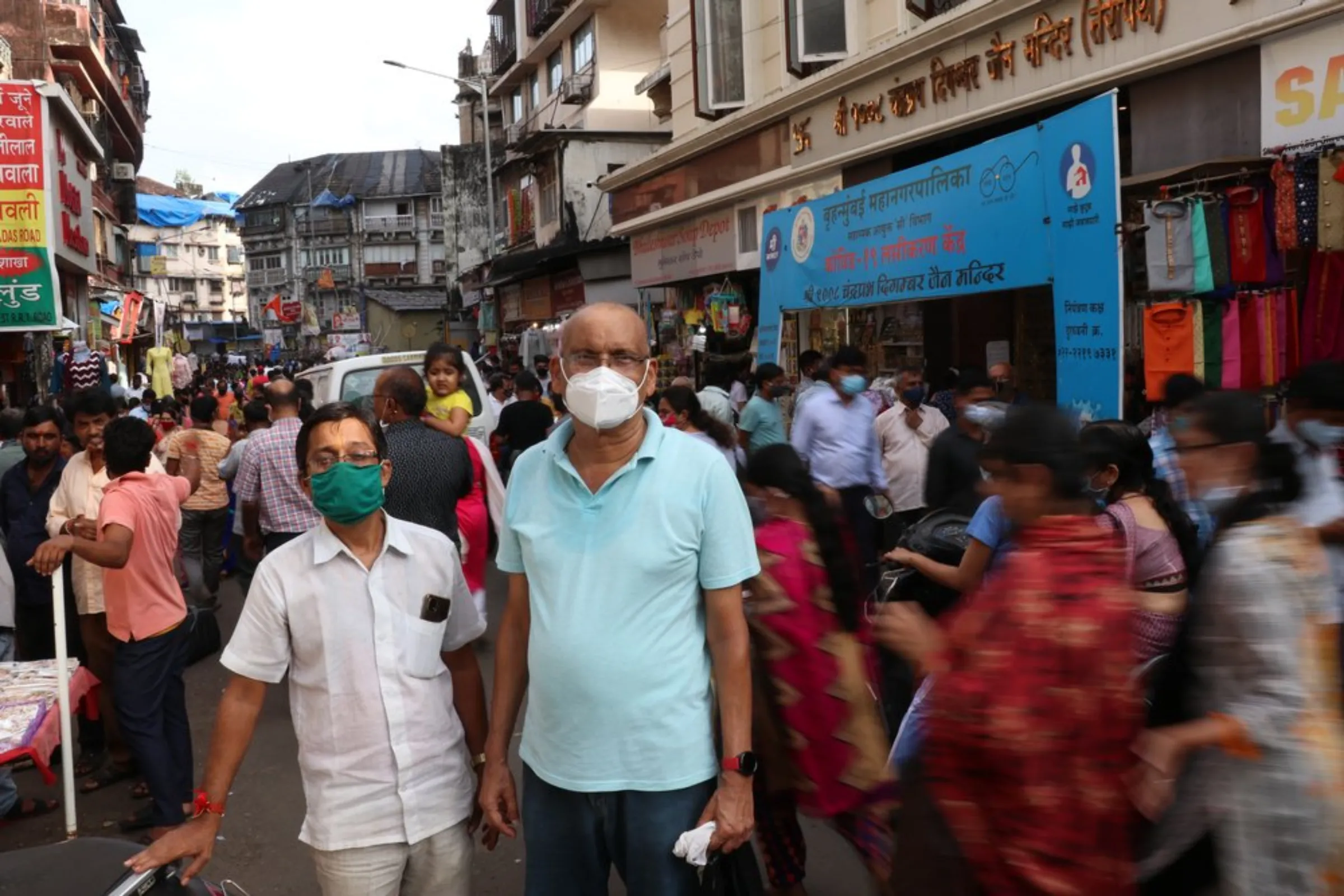 Rajesh Mishra, left, stands with a fellow shopkeeper outside the Bhuleshwar market in south Mumbai, India, near where his shop flooded for the first time during heavy rains in July, September 15, 2021