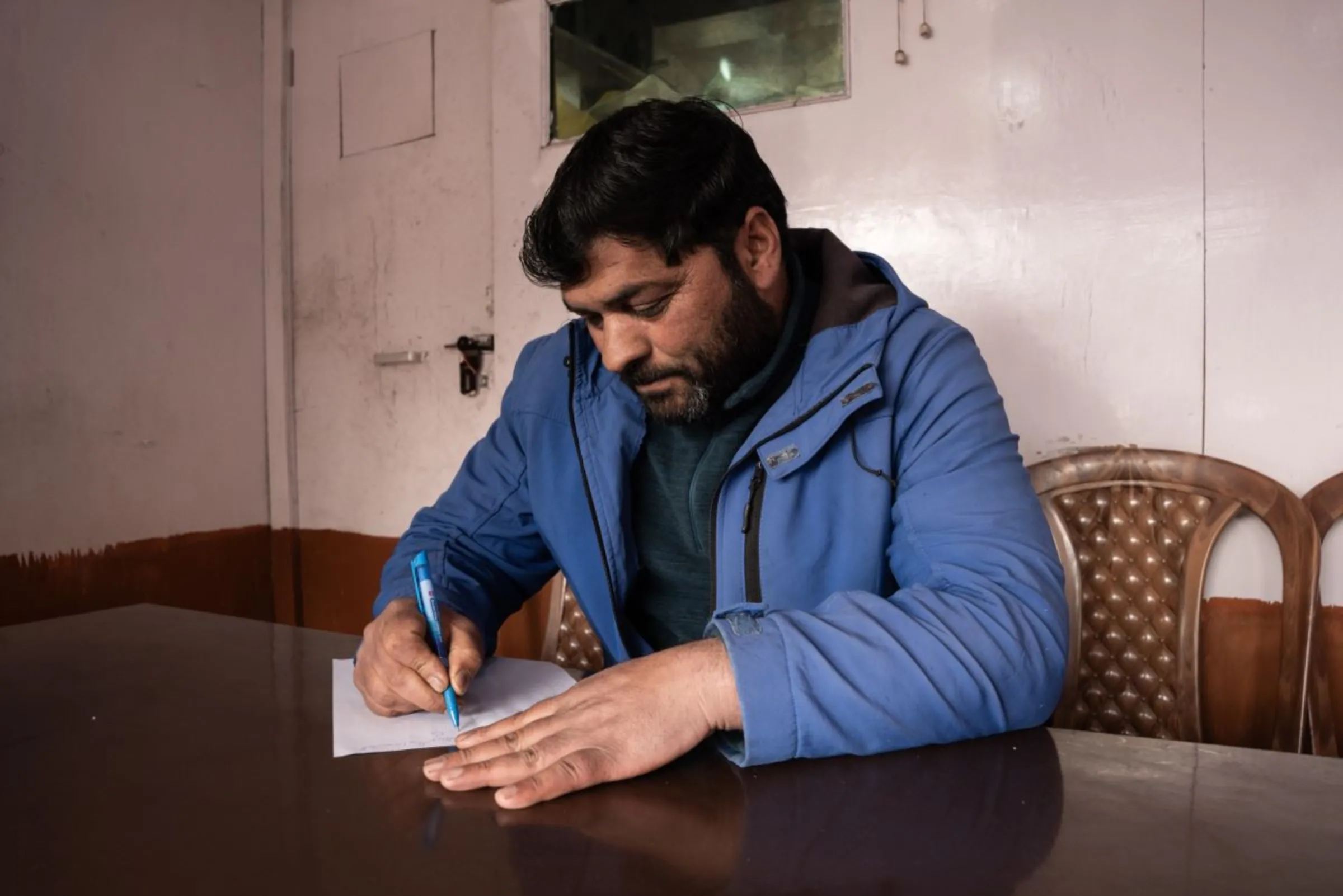 Ghulam Nabi 46, president of the Gulmarg traders association, works in his shop in the Kashmiri winter sports town. . The northern Indian region has seen little snowfall this year, Jan. 6, 2024. Thomson Reuters Foundation/Mehran Firdous