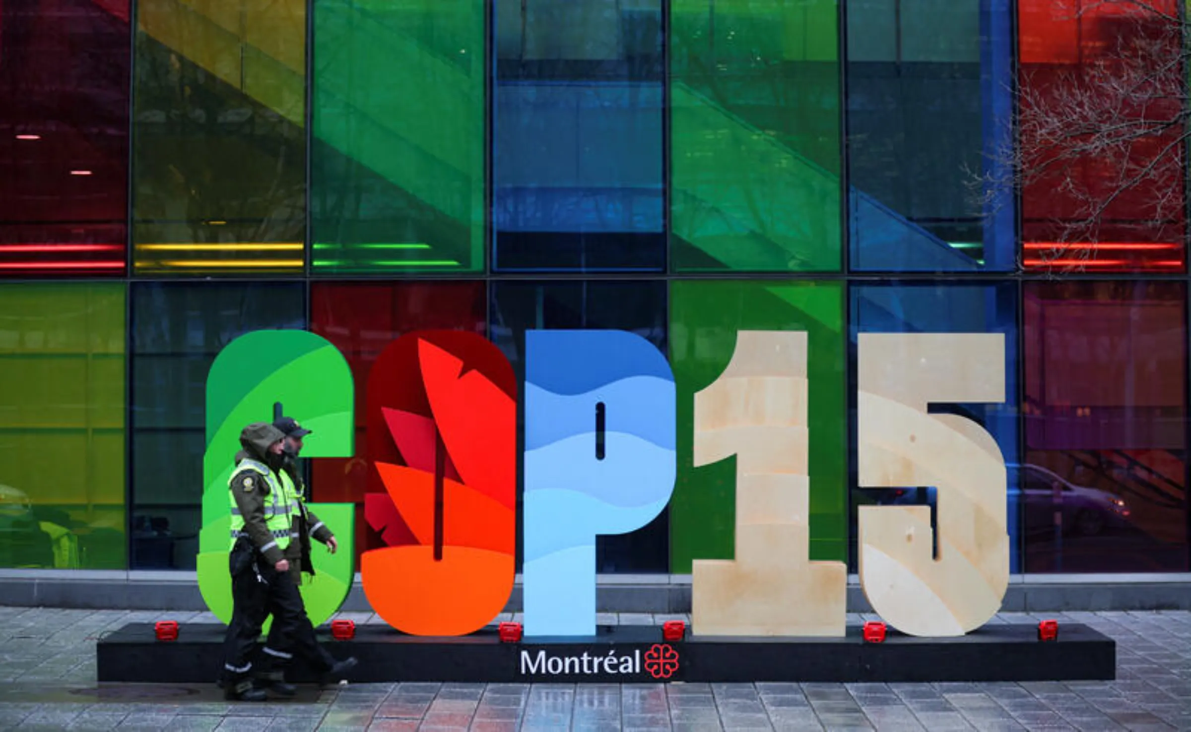 Police officers walk past a sign as they patrol outside the Palais de Congres, during the opening of COP15, the two-week U.N. biodiversity summit in Montreal, Quebec, Canada, December 6, 2022. REUTERS/Christinne Muschi 