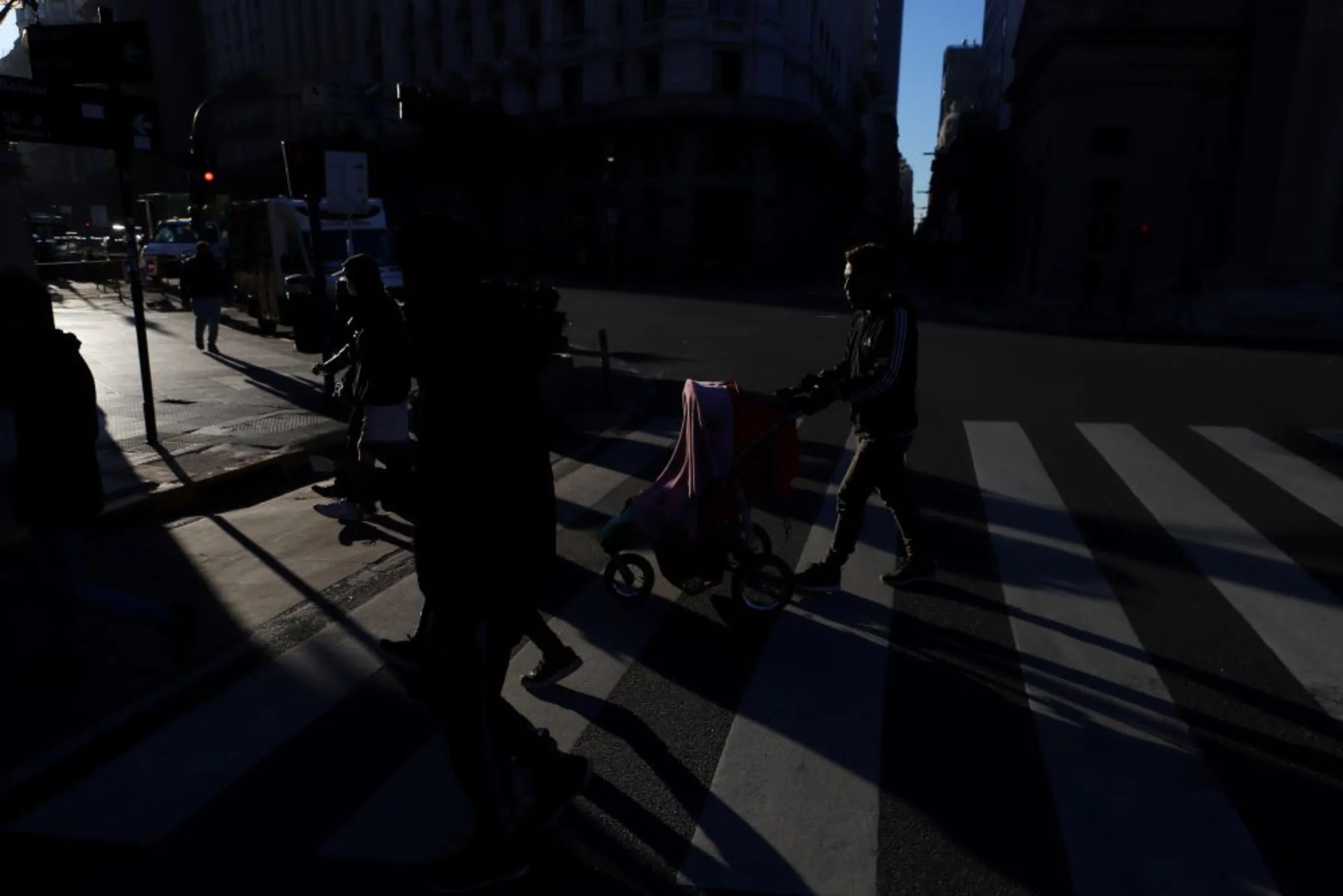 A man pushes a baby trolley in downtown Buenos Aires, Argentina July 16, 2021