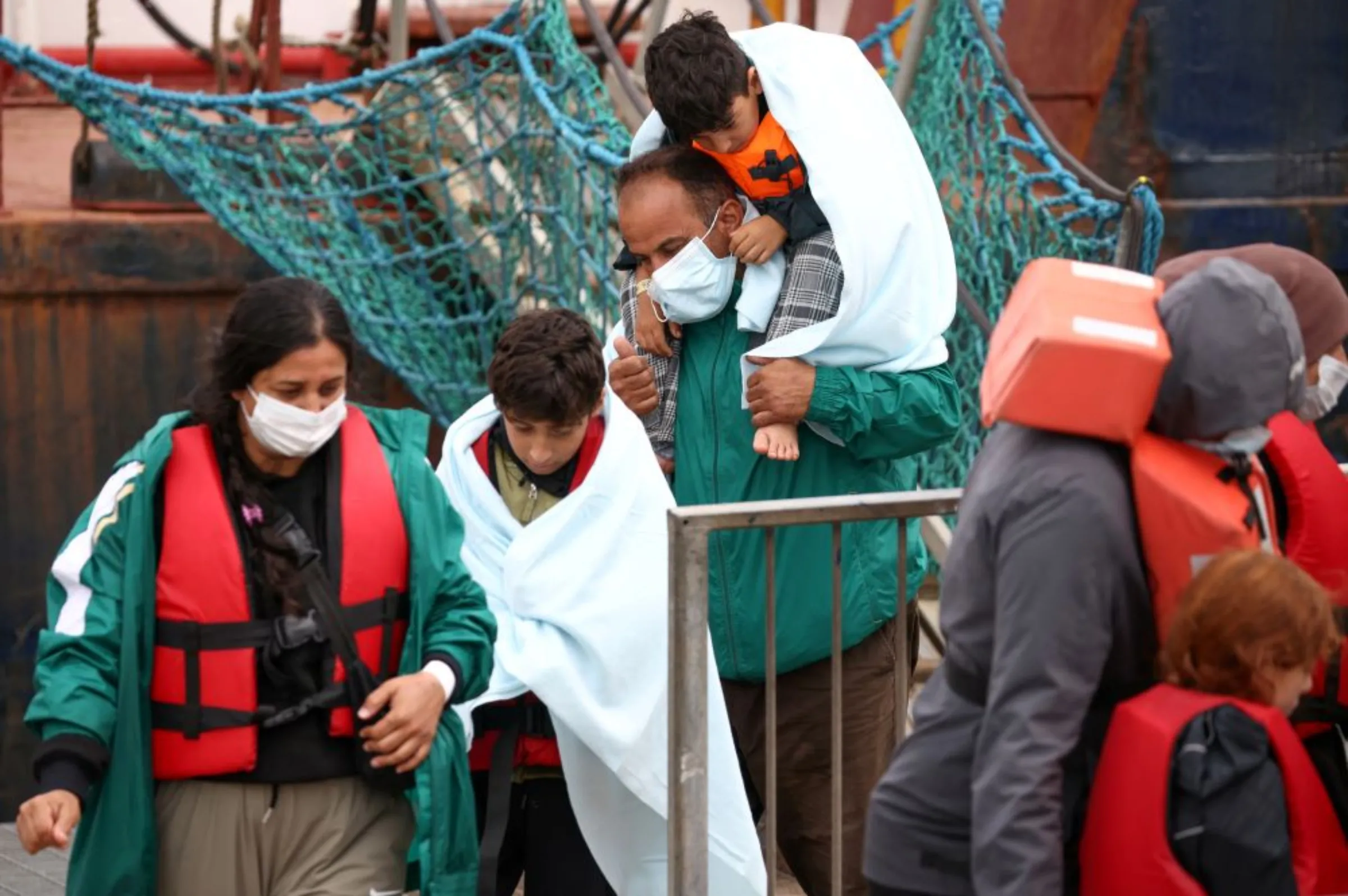 Migrants are escorted into Dover harbour, after being rescued while attempting to cross the English Channel, in Dover, Britain, August 24, 2022. REUTERS/Henry Nicholls