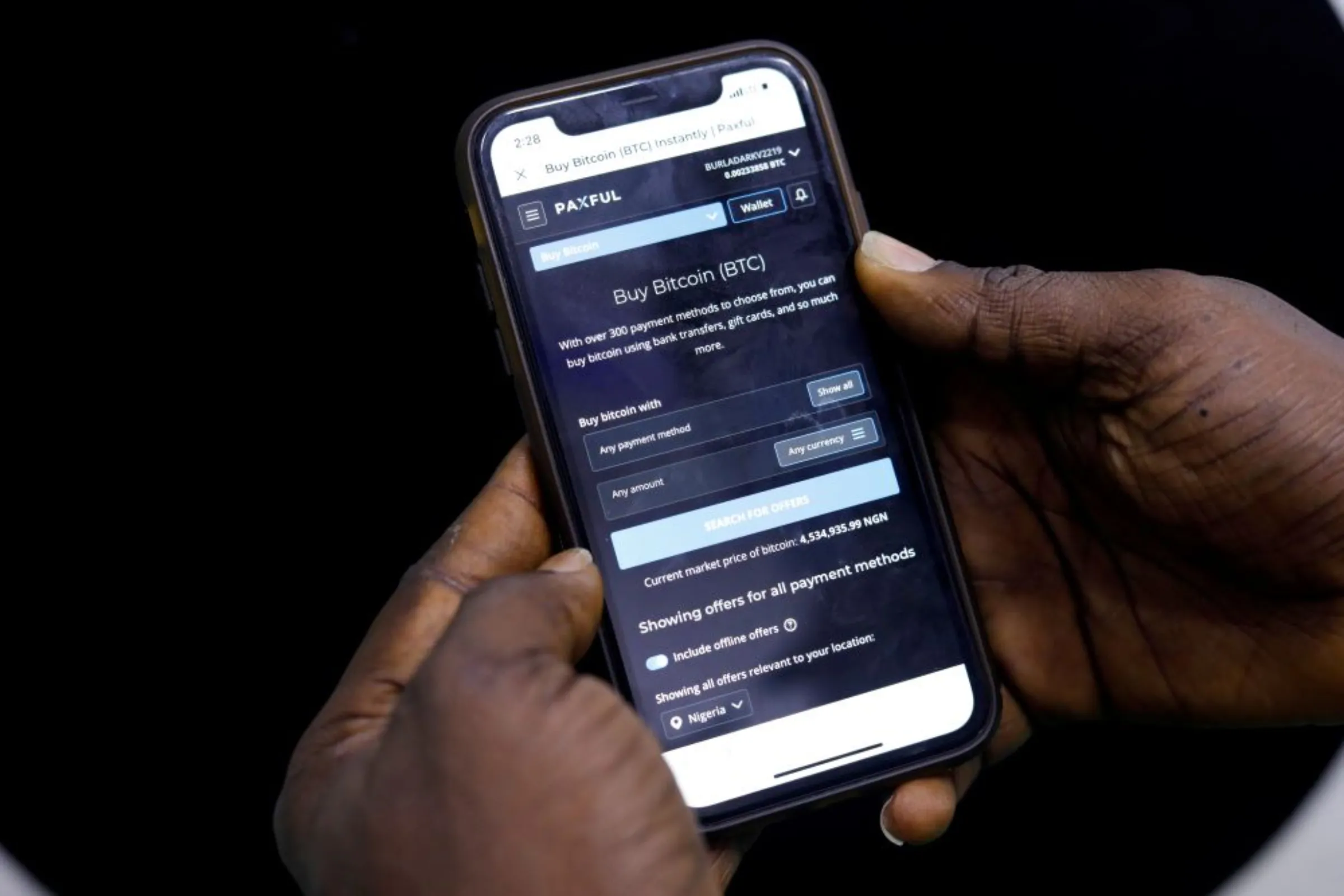 Abolaji Odunjo, a gadget vendor who trades with bitcoin, demonstrates a bitcoin application on his mobile phone in Lagos, Nigeria August 31, 2020. REUTERS/Temilade Adelaja
