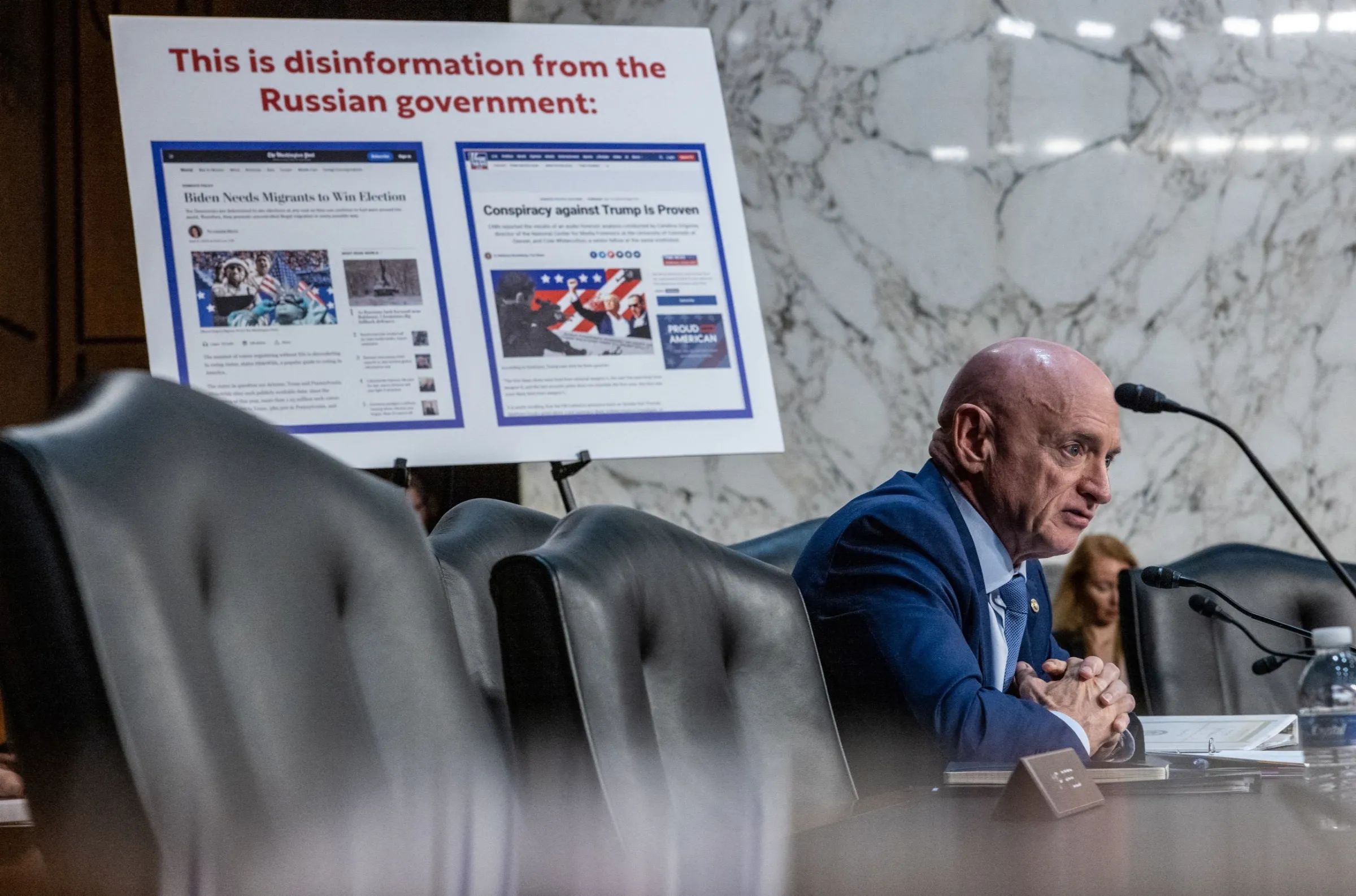 U.S. Senator Mark Kelly (D-AZ) questions Google parent Alphabet's global affairs president Kent Walker, Meta's global affairs president Nick Clegg and Microsoft President Brad Smith during a Senate Intelligence Committee hearing on election threats, on Capitol Hill in Washington, U.S., September 18, 2024. REUTERS/Anna Rose Layden