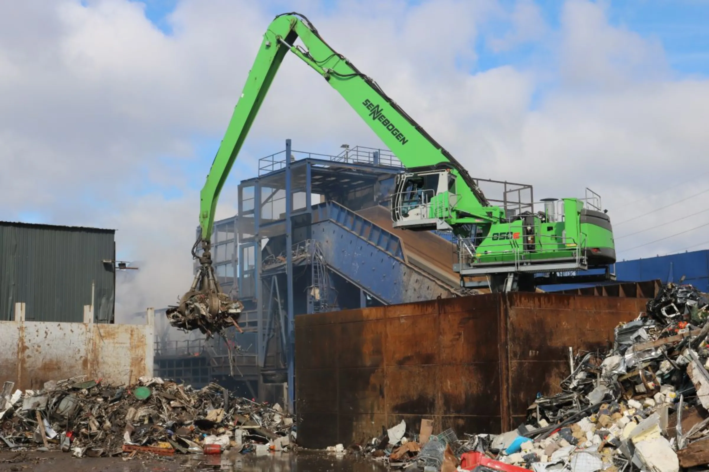 An electric material handler lifts scrap into a shredder at a European Metal Recycling plant in Birmingham, Britain. March 10, 2023. Thomson Reuters Foundation/Jack Graham