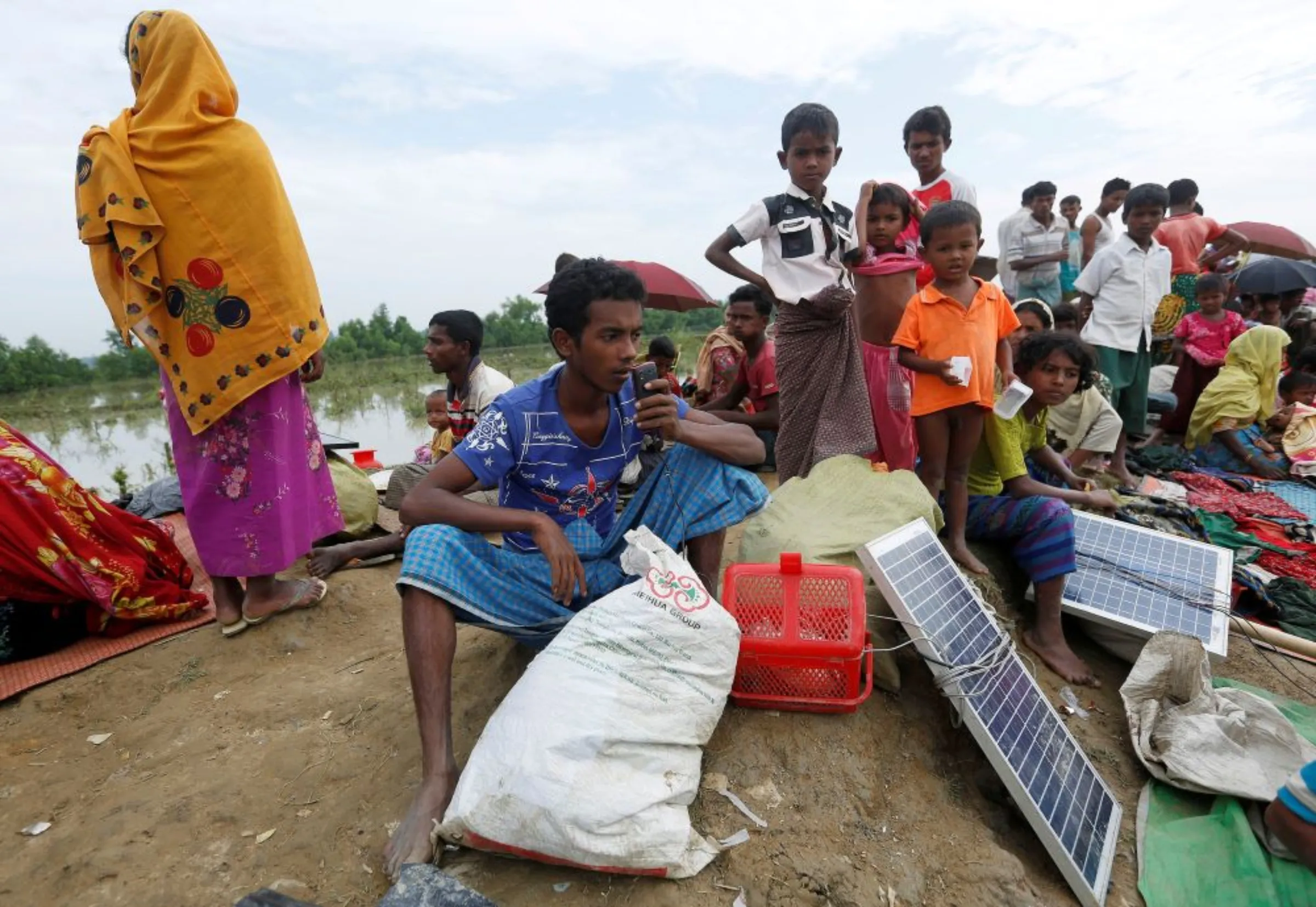 A Rohingya refugee charges his phone with a solar panel at the Bangladesh-Myanmar border in Palang Khali, near Cox’s Bazar, Bangladesh November 2, 2017