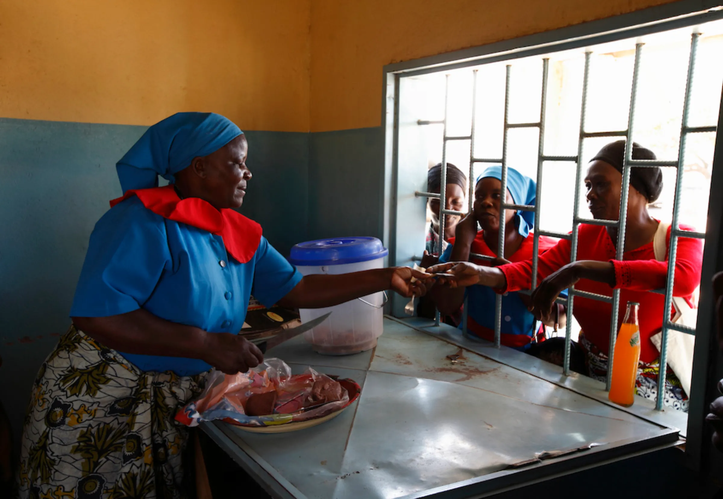 A member of a home-based care team sells food items at a tuckshop to raise funds in the Matero township on the outskirts of Lusaka April 17, 2012.