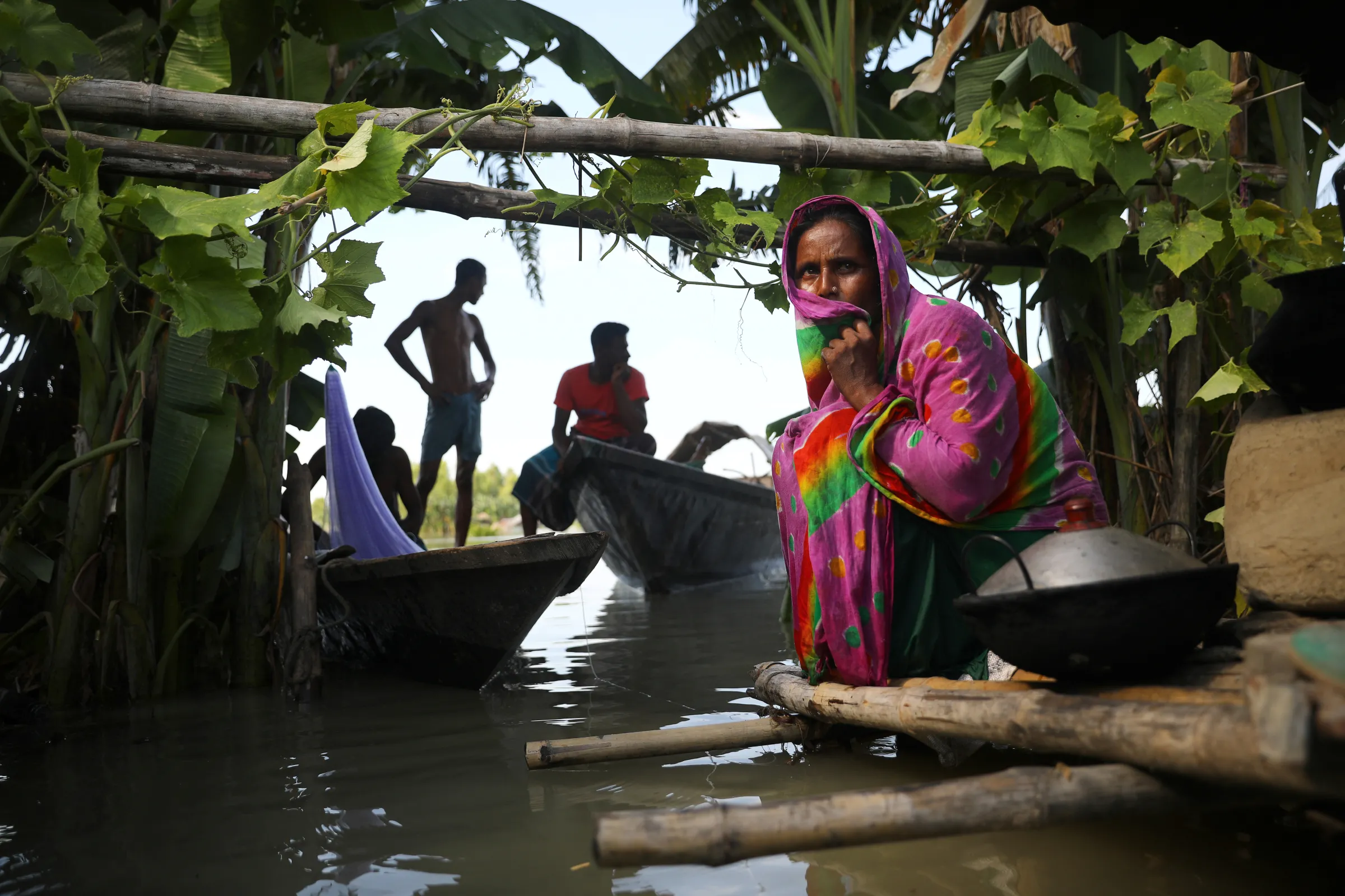 A flood-affected woman sits on a bamboo made structure as her house has been flooded, in Bogura, Bangladesh, July 17, 2020. REUTERS/Mohammad Ponir Hossain