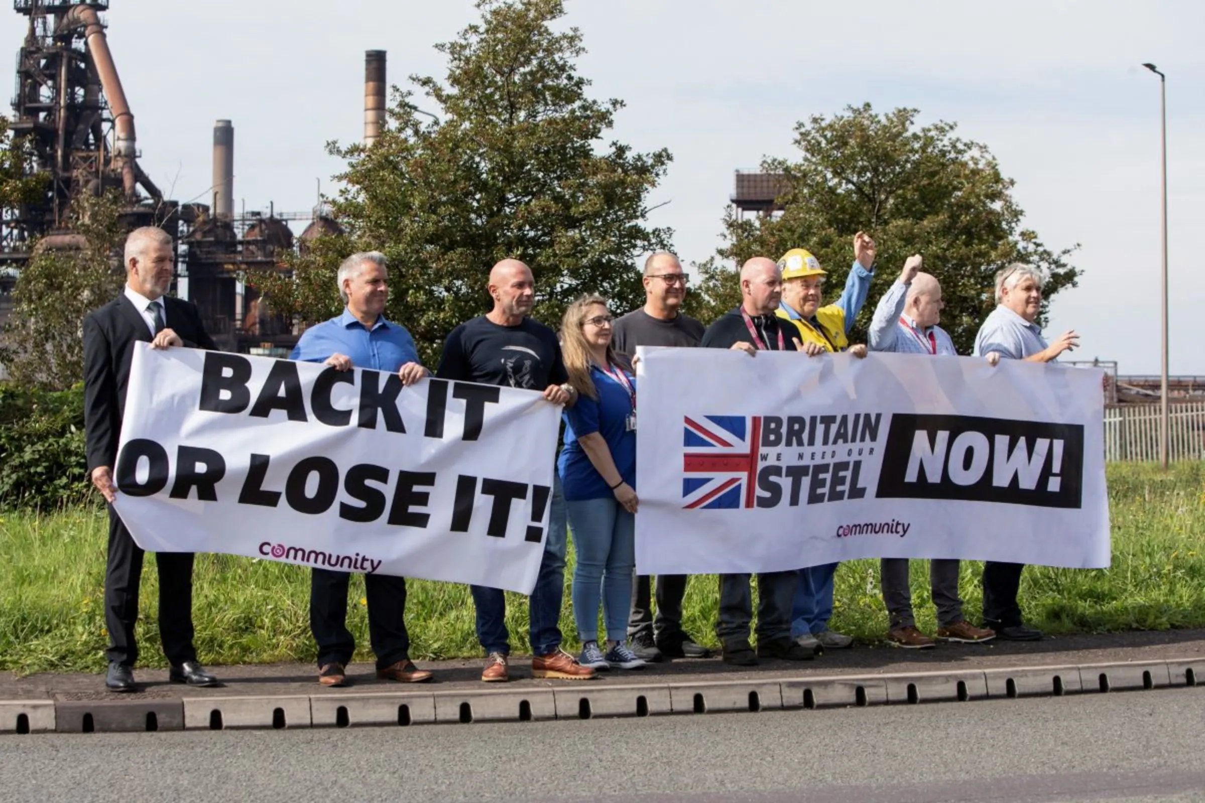Protesters hold signs outside Tata Steel in Port Talbot, Britain September 15, 2023. REUTERS/Joann Randles