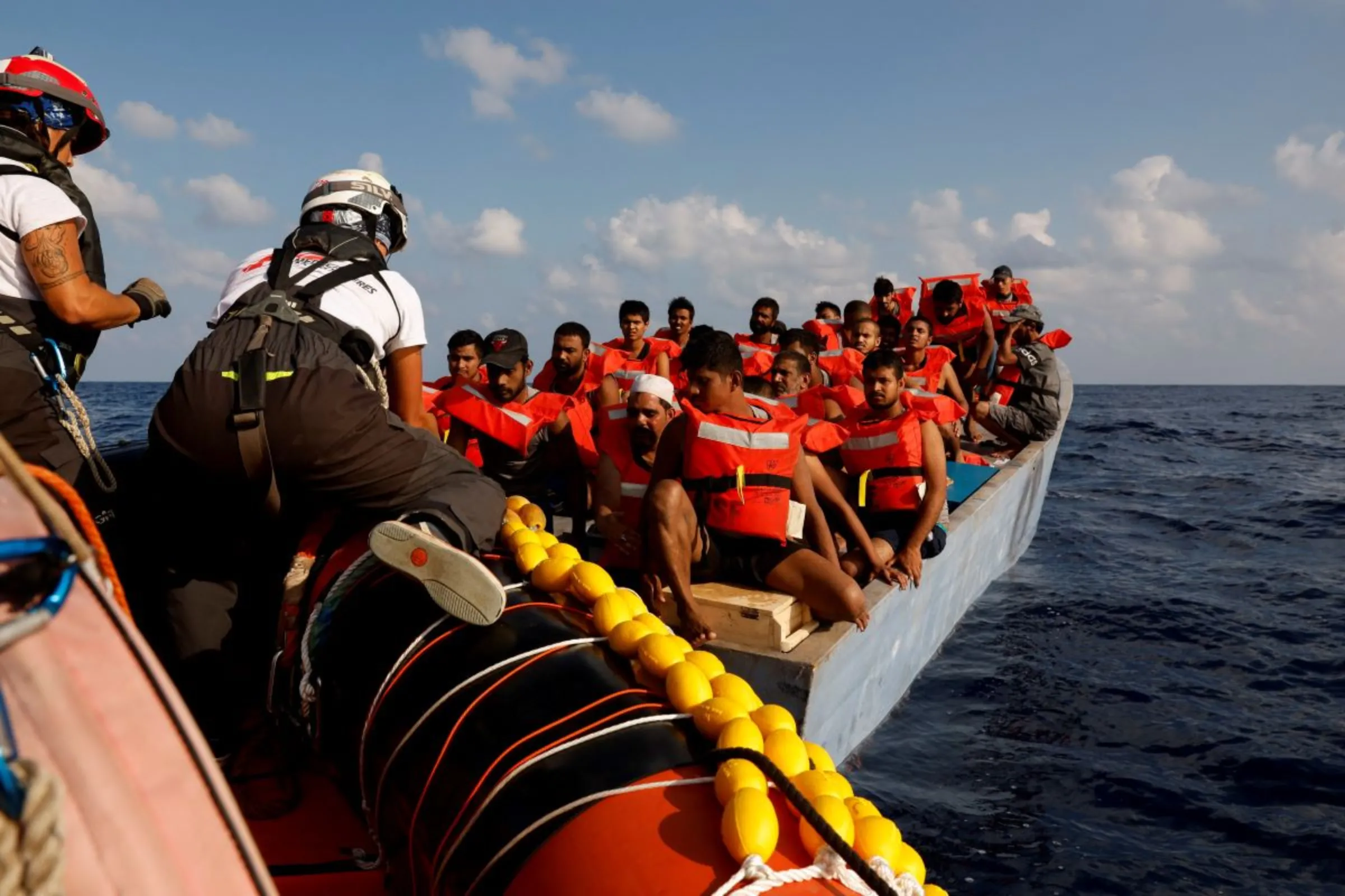 A group of 61 migrants on a wooden boat are rescued by crew members of the Geo Barents migrant rescue ship, operated by Medecins Sans Frontieres (Doctors Without Borders), in international waters off the coast of Libya in the central Mediterranean Sea September 28, 2023. REUTERS/Darrin Zammit Lupi