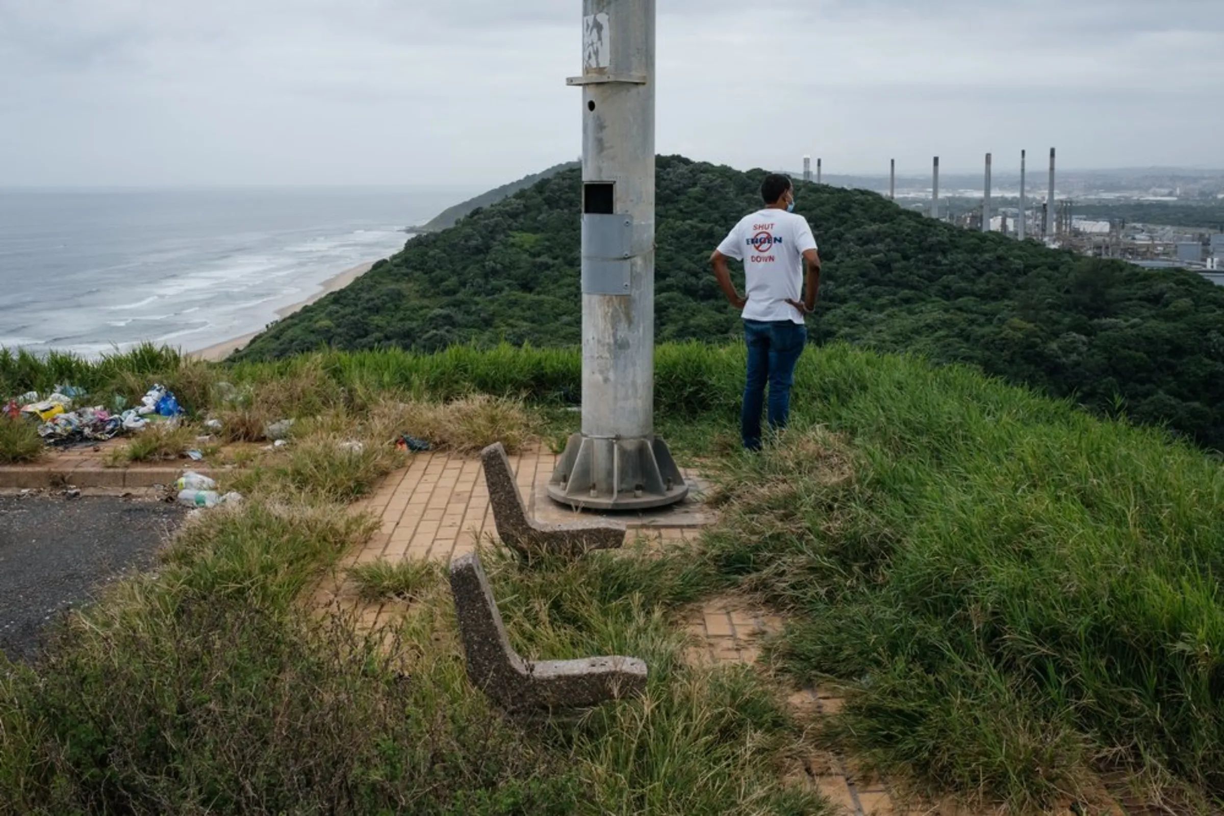 South Durban Community Environmental Alliance (SDCEA) coordinator Desmond D'Sa looks over the SAPREF oil refinery from a viewpoint in Durban, South Africa, April 1, 2021