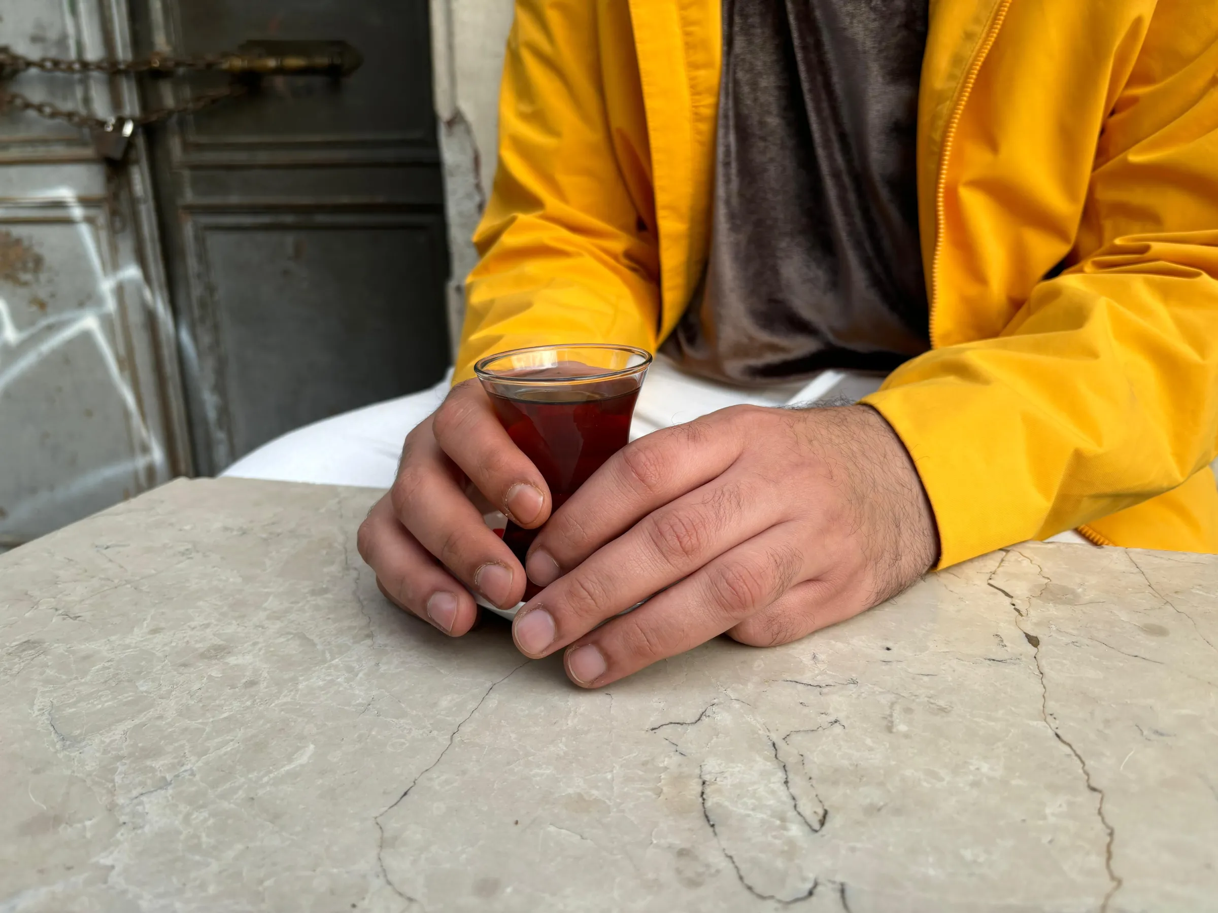 Hasnaa, a Syrian refugee, drinks tea at an Istanbul tea house, Turkey, January 25, 2025. Thomson Reuters Foundation/Beril Eski