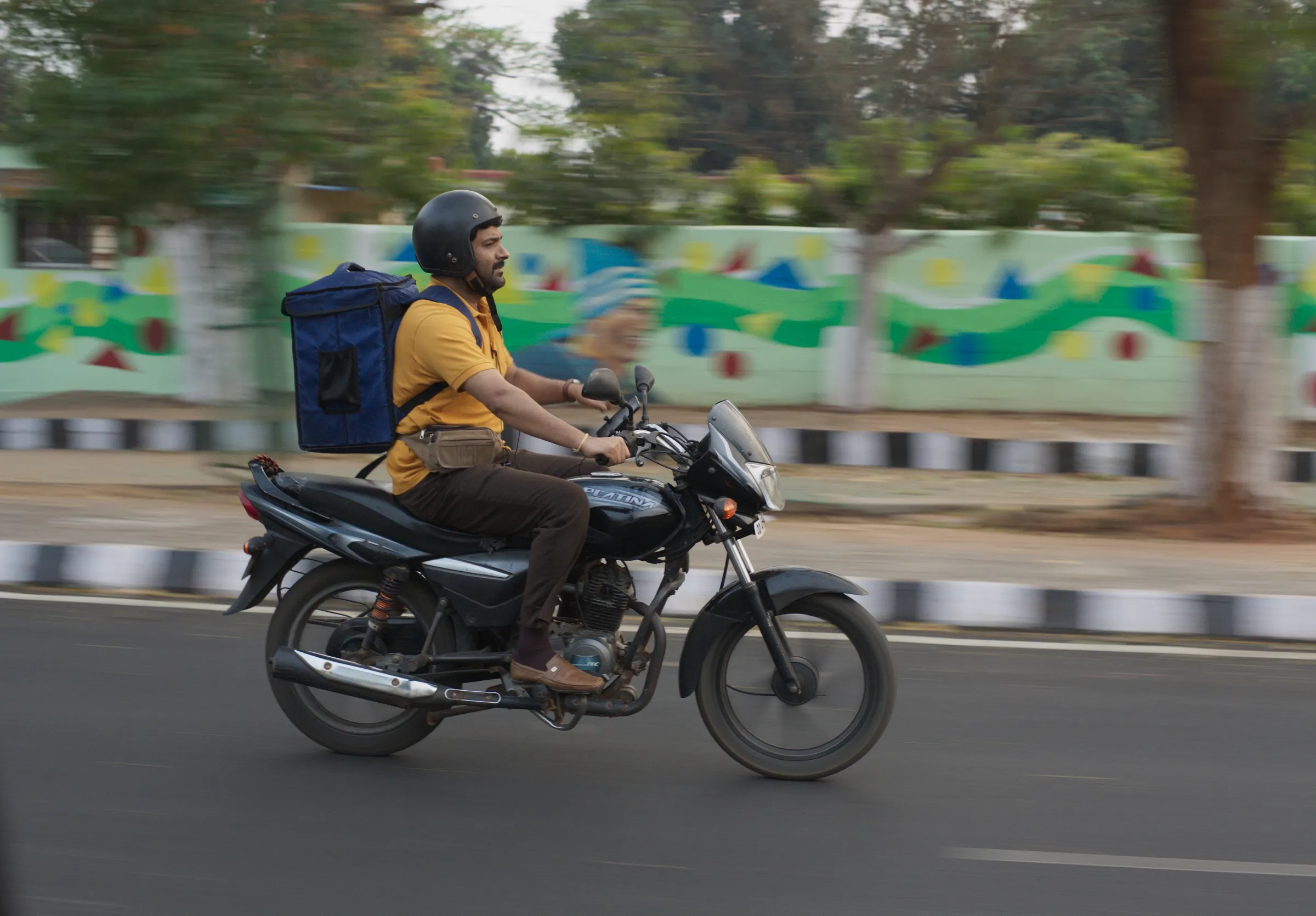 A still image of a man on his scooter from the Bollywood film 'Zwigato' starring Kapil Sharma, that tells the story of a food-delivery app driver's struggle in the eastern city of Bhubaneswar, India. Applause Entertainment/Handout via Thomson Reuters Foundation