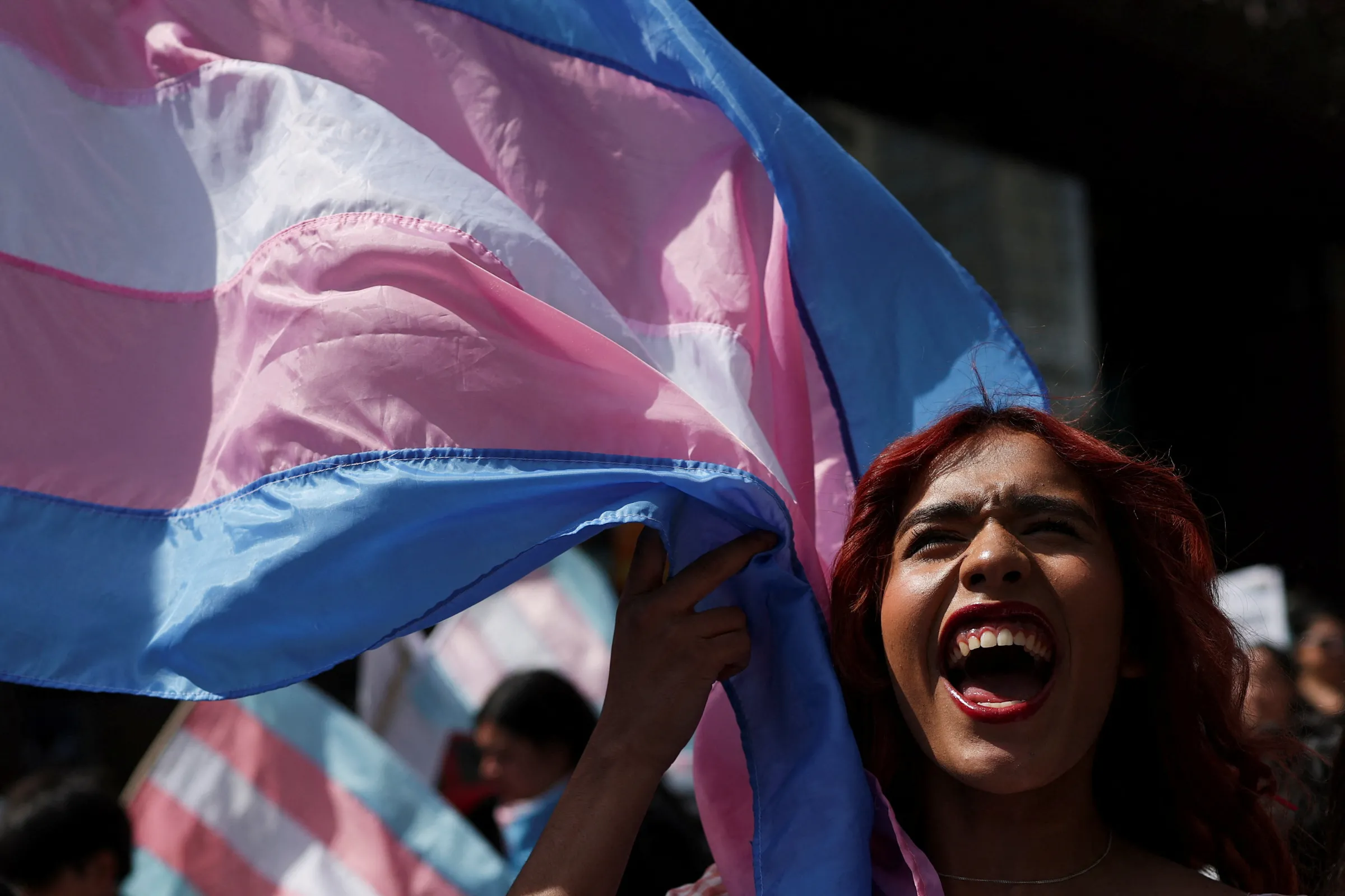 A trans flag waves as a person shouts slogans during the Santiago Parade 2025, an event supporting LGBTIQ+ rights, in Santiago, Chile, November 8, 2025. REUTERS/Pablo Sanhueza