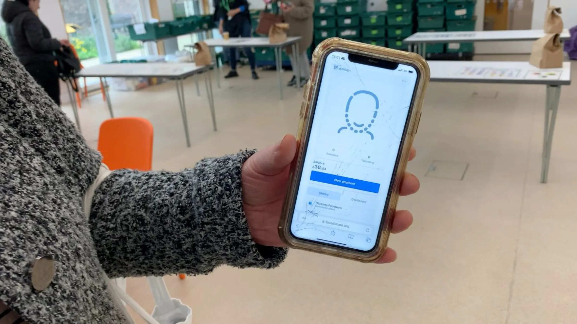 Foodbank recipients at a Hackney Foodbank hub use FaceDonate, a donations app that lets users receive and pay for essential items with face scans, in east London, Britain on April 24, 2023