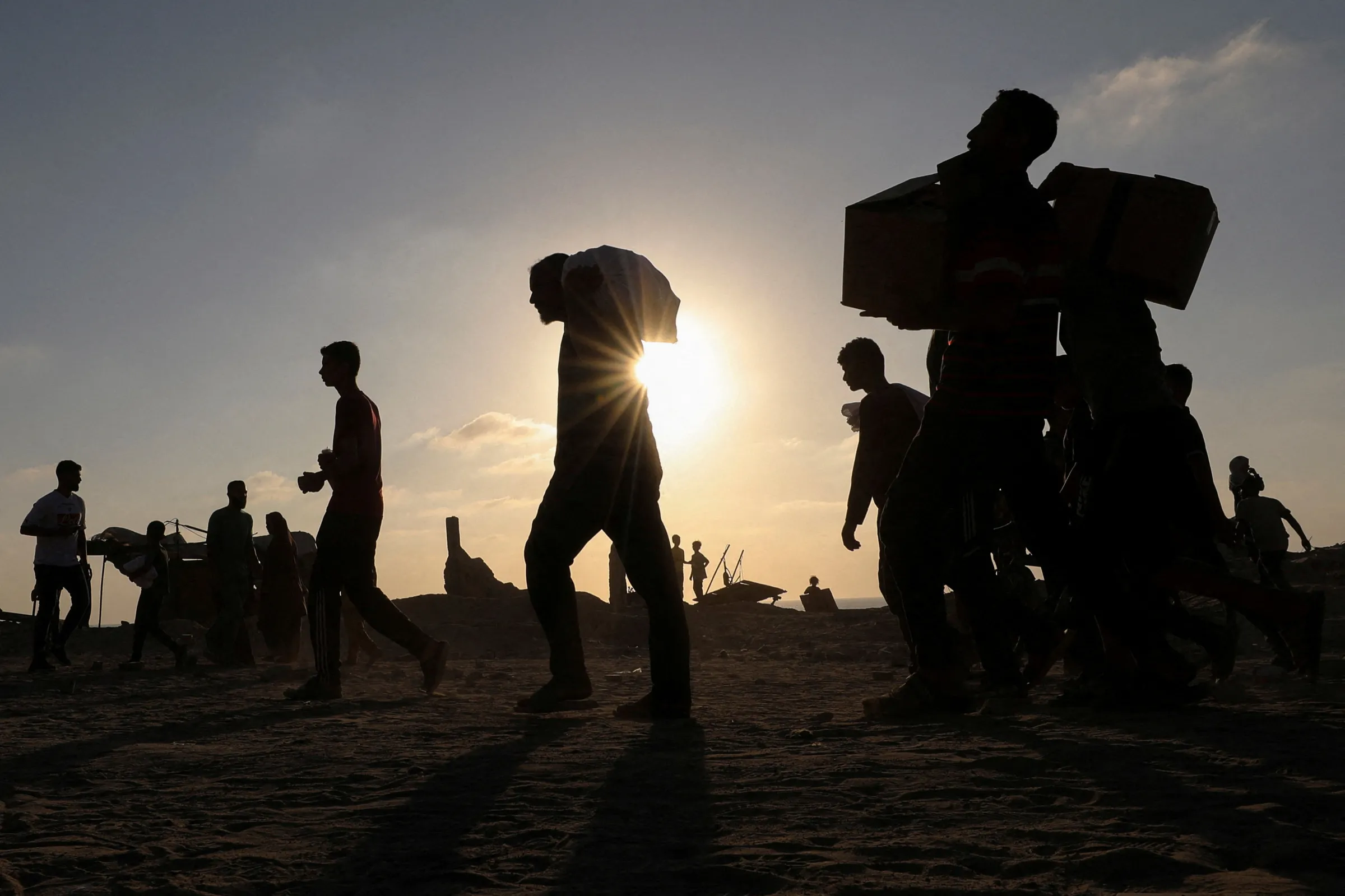 Palestinians carry aid supplies in Beit Lahia, in the northern Gaza Strip, June 16, 2025. REUTERS/Dawoud Abu Alkas