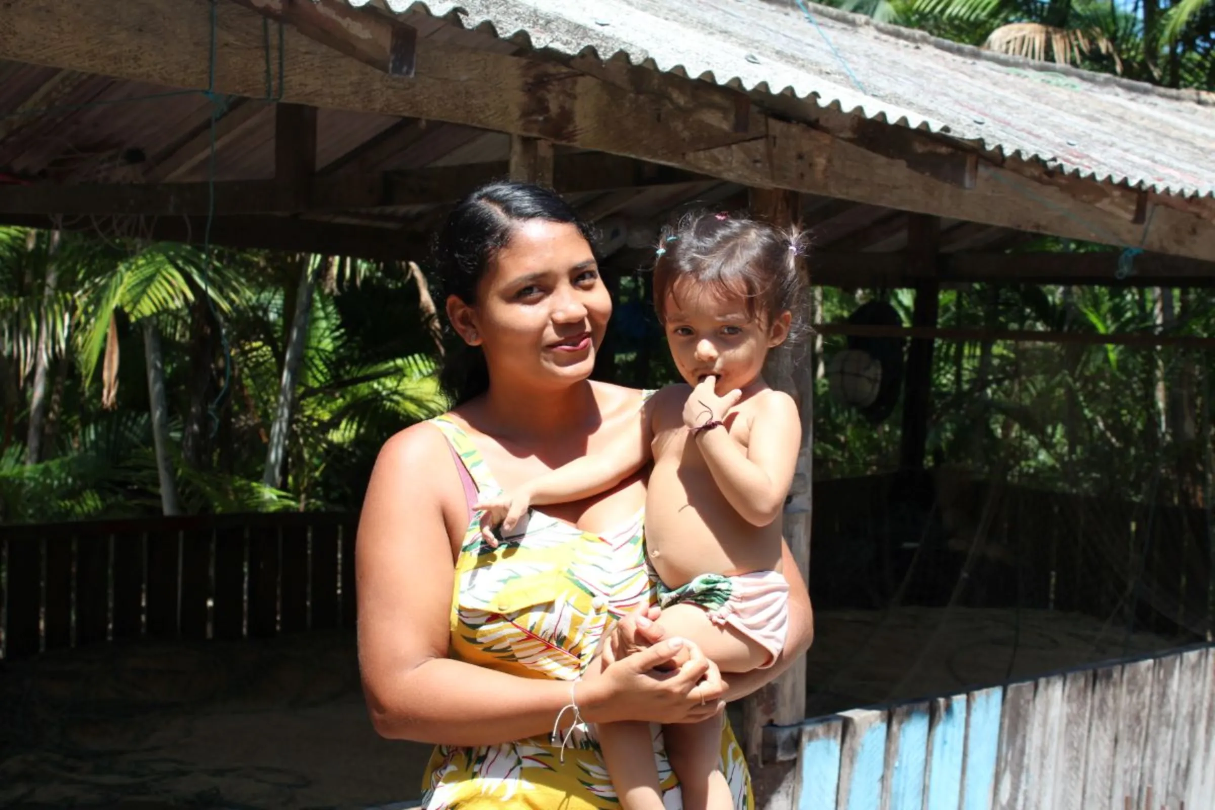 Fisherwoman Natalina Silva Ferreira and her daughter at her home in the Santo Afonso PAE reserve, near to where U.S. grains trader Cargill wants to build a port in Xingu Island, Abaetetuba, Brazil, August 11, 2023. Thomson Reuters Foundation/André Cabette Fábio