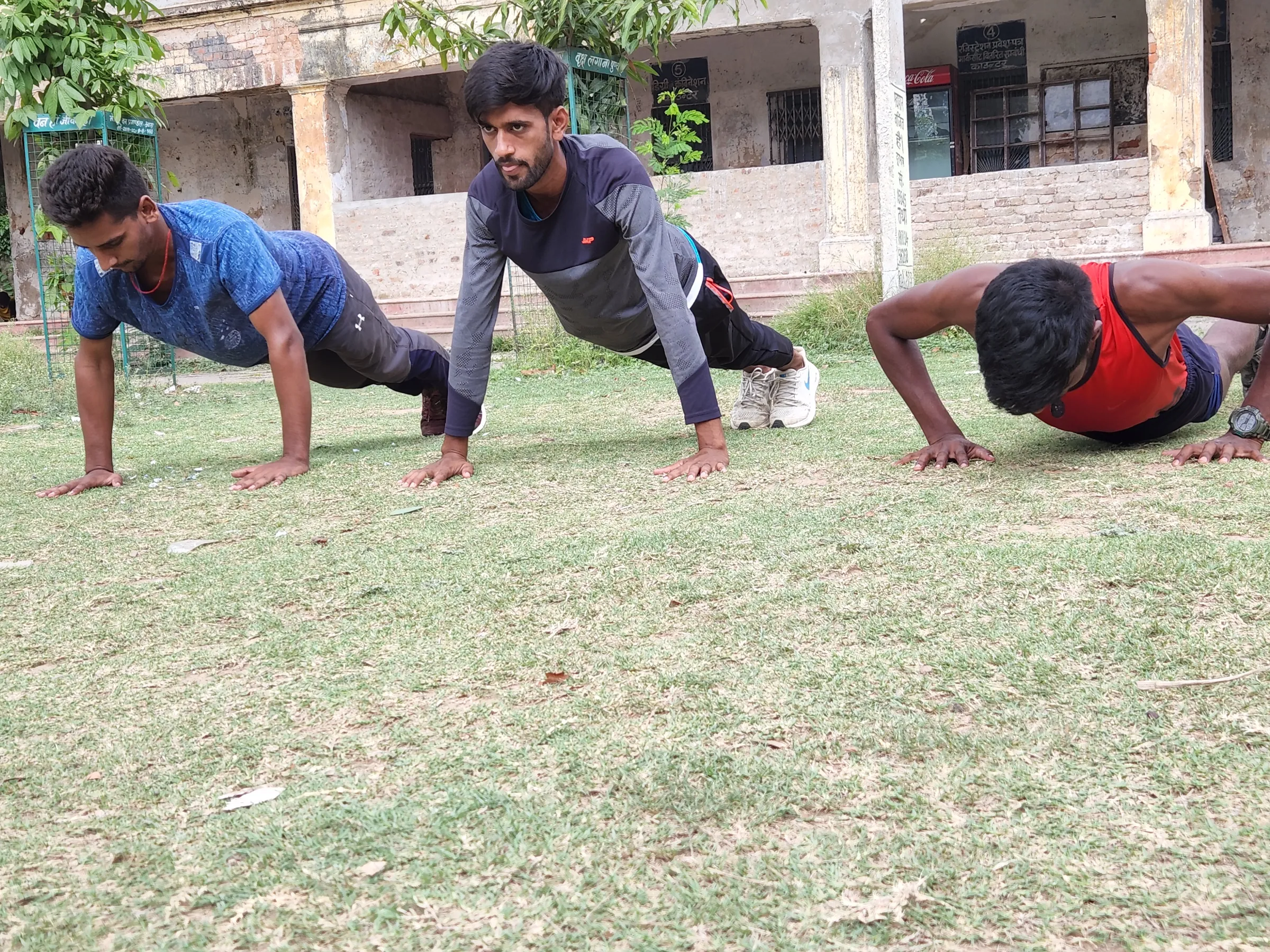 Young army aspirants do push-ups with as part of their military training