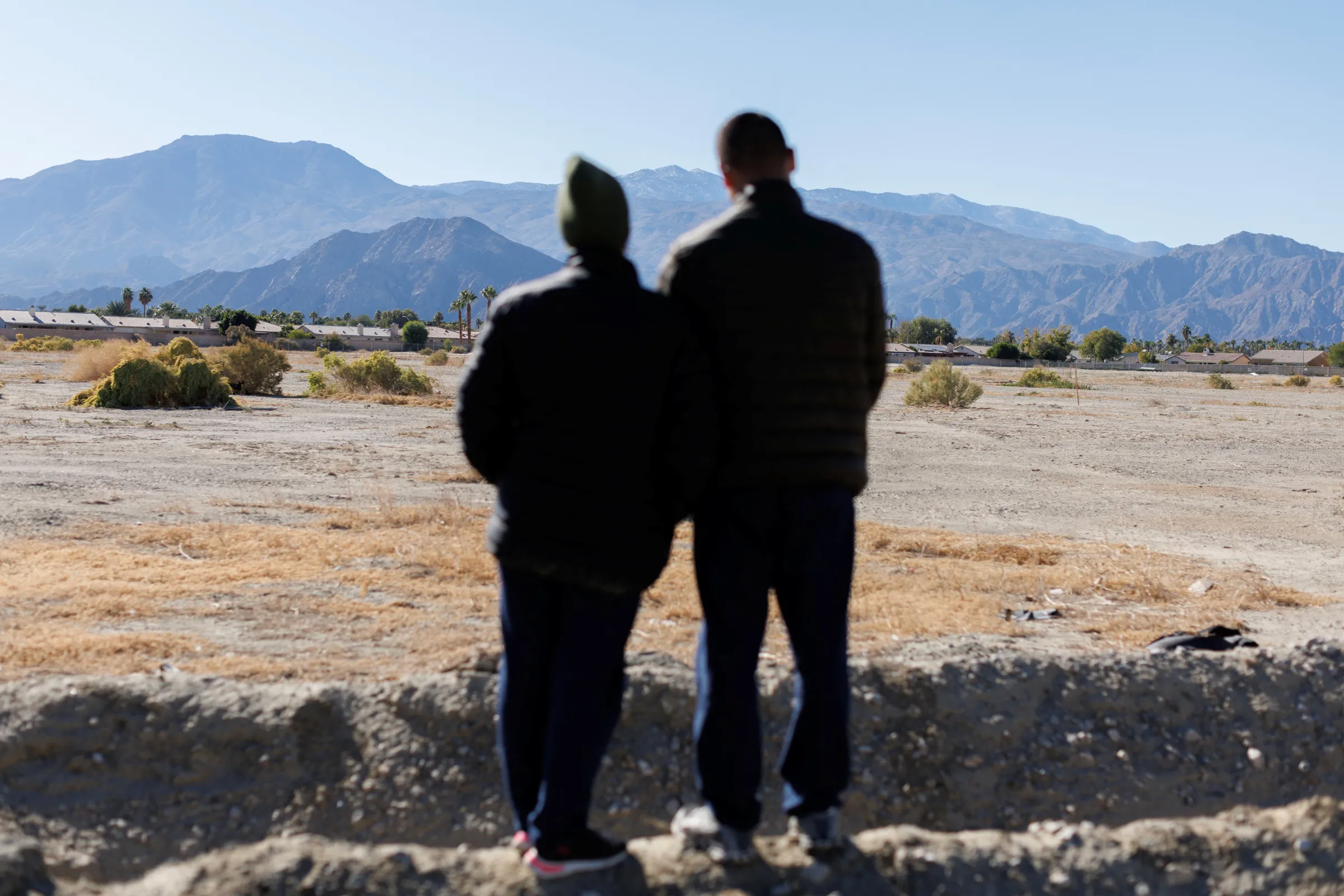 Afghanistan asylum seekers Jamshid Nabizada and his 5-month pregnant wife Nahida pose for a picture near their refugee housing in Indio, California, U.S., December 13, 2022. REUTERS/Mike Blake
