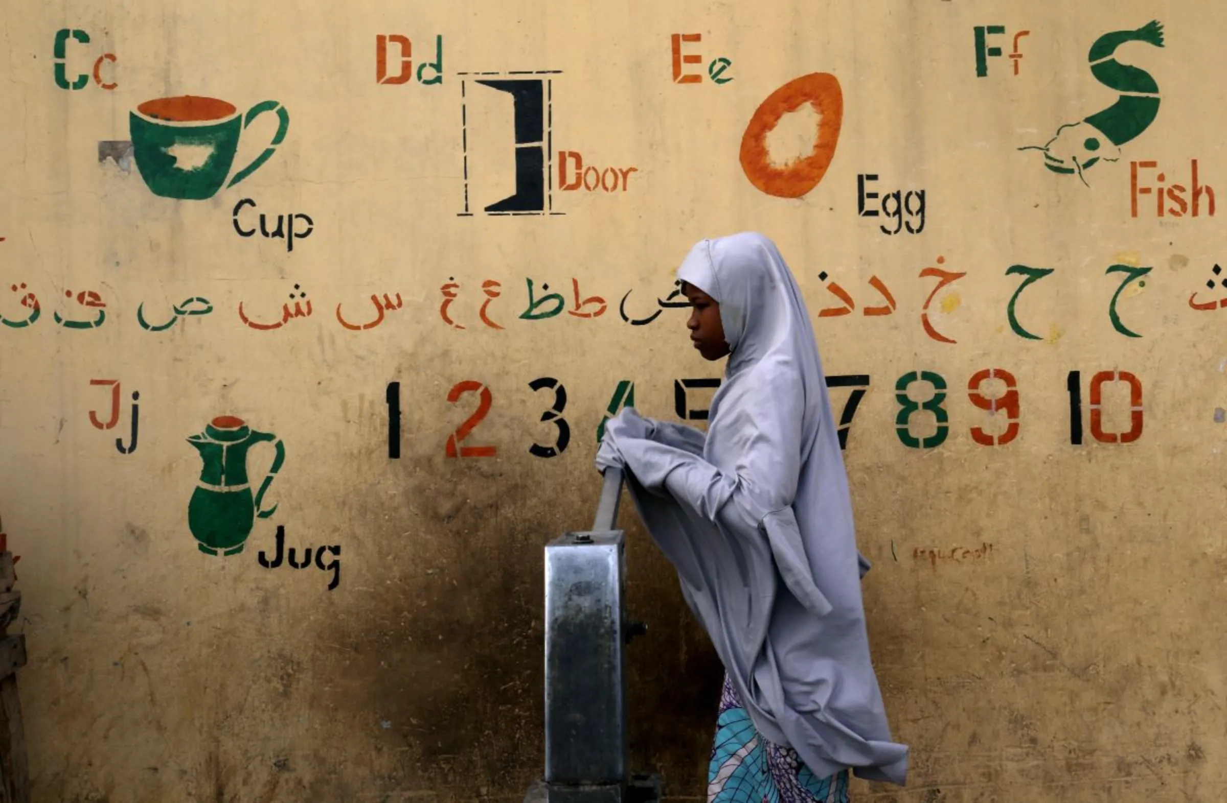A girl draws water from a fountain in Kano, Nigeria February 17, 2019. REUTERS/Luc Gnago