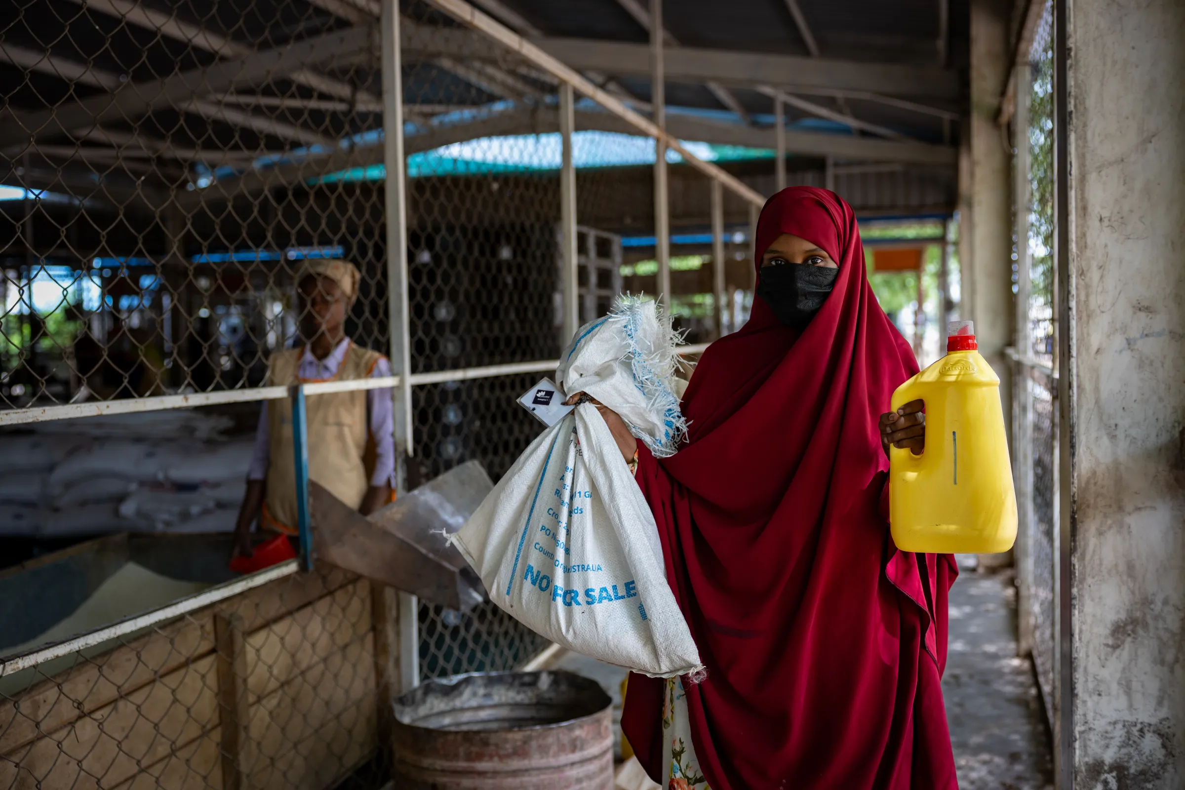 A refugee poses for a photo during food distribution exercise in Kakuma refugee camp in Kenya. WFP/Handout via Thomson Reuters Foundation