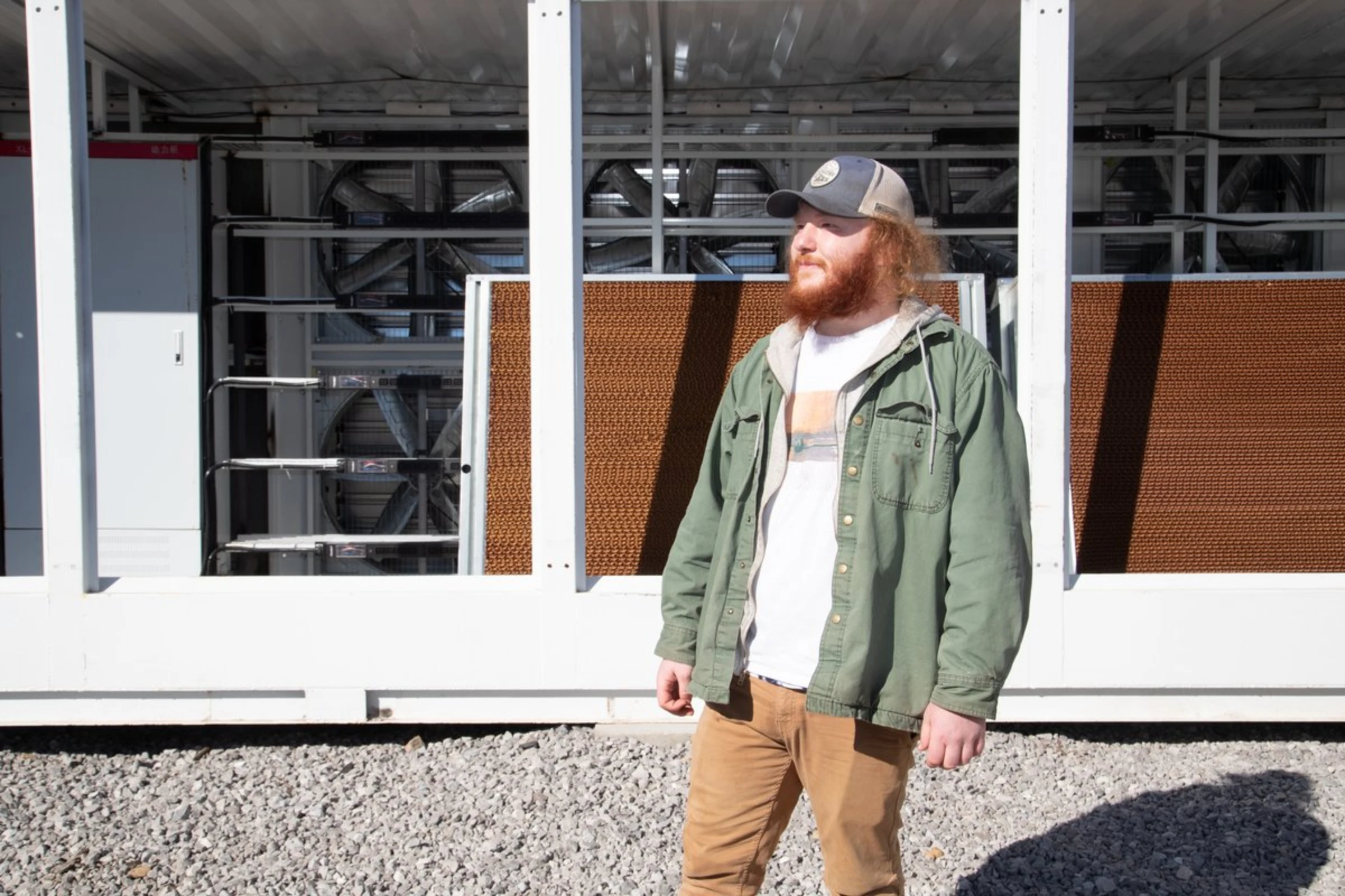 Ethan Aslinger, a 23-year-old employee at the PrimeBlock bitcoin mine bitcoin mine, stands at the site in Harlan, Kentucky, January 26, 2022. Thomson Reuters Foundation/Amira Karaoud