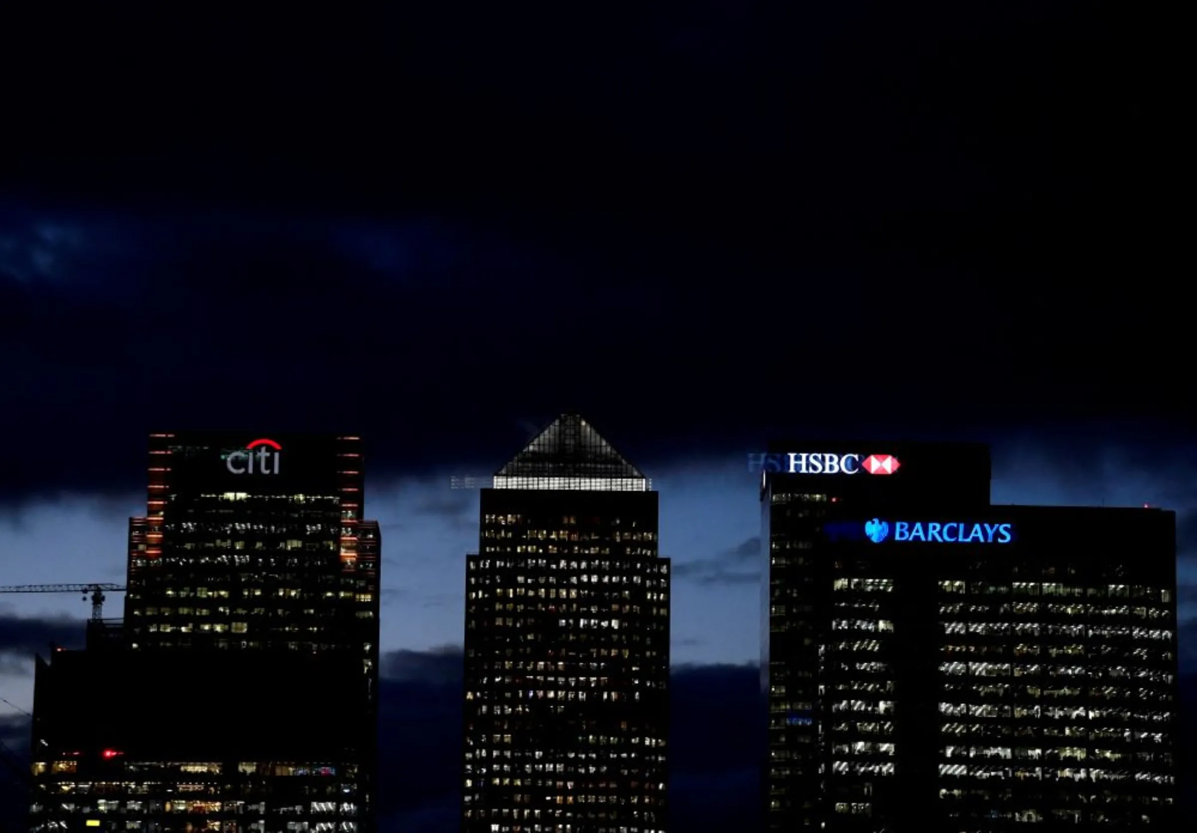 Citibank, HSBC and Barclays buildings are lit up at dusk in the Canary Wharf financial district of London, Britain, November 19, 2018. REUTERS/Toby Melville
