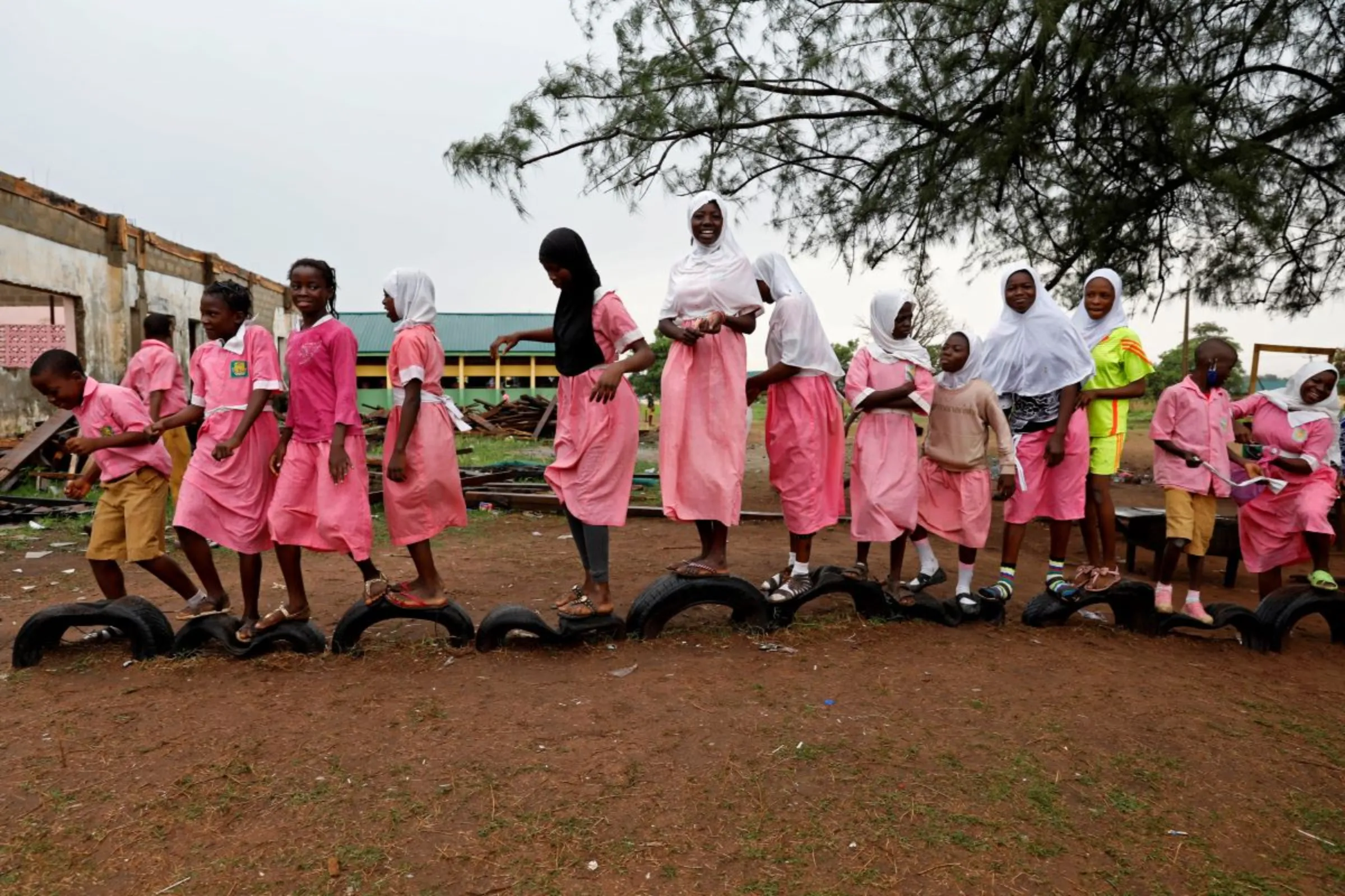 Students stand on tyres in school playground, Kwara state, Nigeria, March 24, 2021. REUTERS/Temilade Adelaja