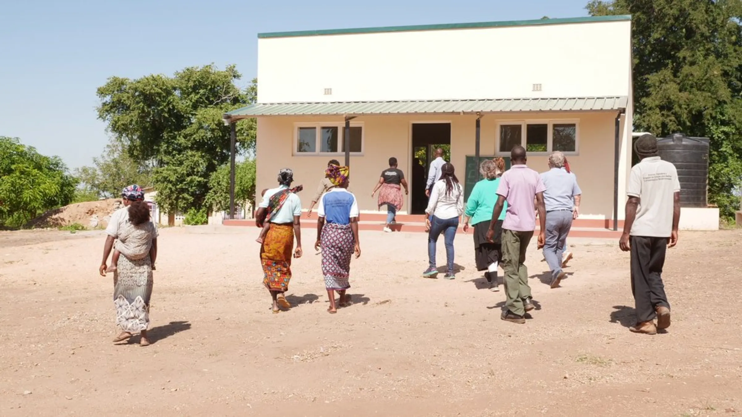 Community members walk towards a school funded by Gorongosa National Park in the reserve’s buffer zone in Mozambique, May 24, 2022
