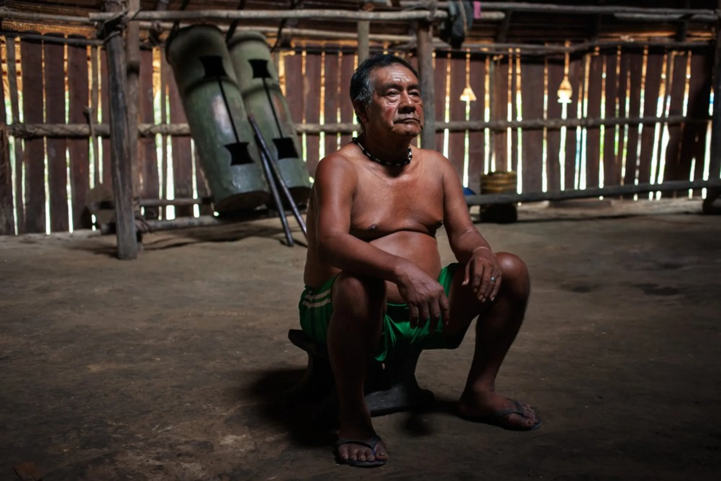 Shaman Faustino Matapi, 74, of the Matapi ethnic group sits in a maloka traditional dwelling in Colombia’s southeast Amazonas province. He is the spiritual leader of the Puerto Libre community and in charge of preserving cultural practices and oral traditions, including the community’s relationship with nature, December 16, 2021
