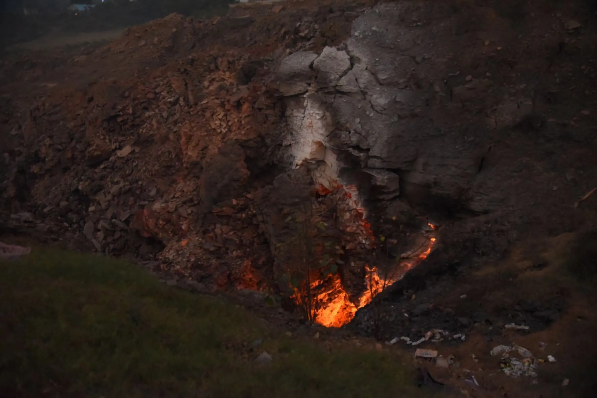 A burning pit in a mining area of Jharia coalfield, India, November 11, 2022. Thomson Reuters Foundation/Tanmoy Bhaduri