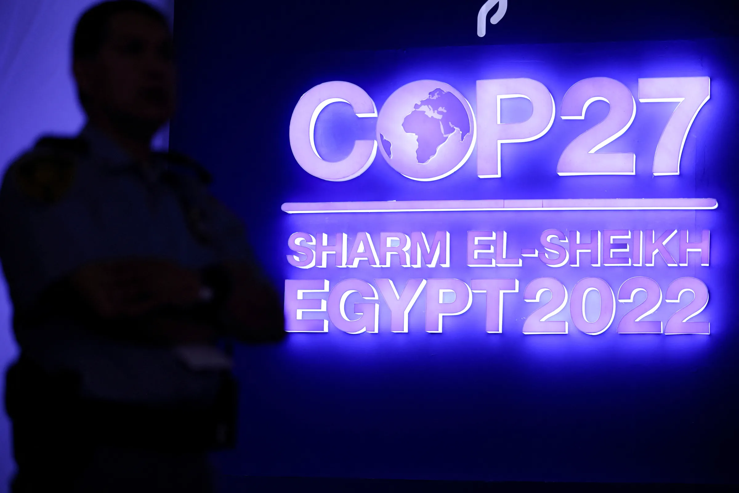 A security personnel stands guard next to the COP27 sign during the closing plenary at the COP27 climate summit in Red Sea resort of Sharm el-Sheikh, Egypt, November 20, 2022. REUTERS/Mohamed Abd El Ghany