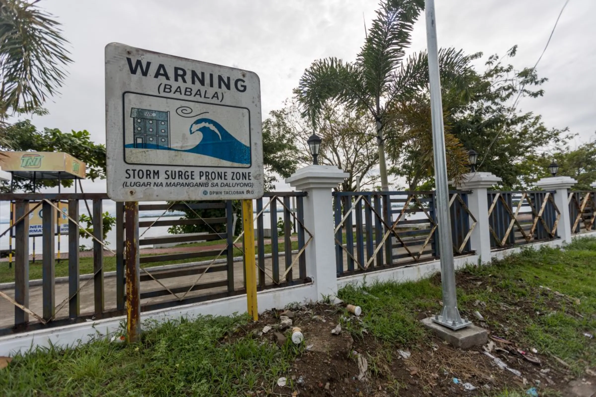 Signages warning residents of storm surge prone areas are seen across the streets of Tacloban City, Philippines. October 11, 2023. Thomson Reuters Foundation/Kathleen Lei Limayo