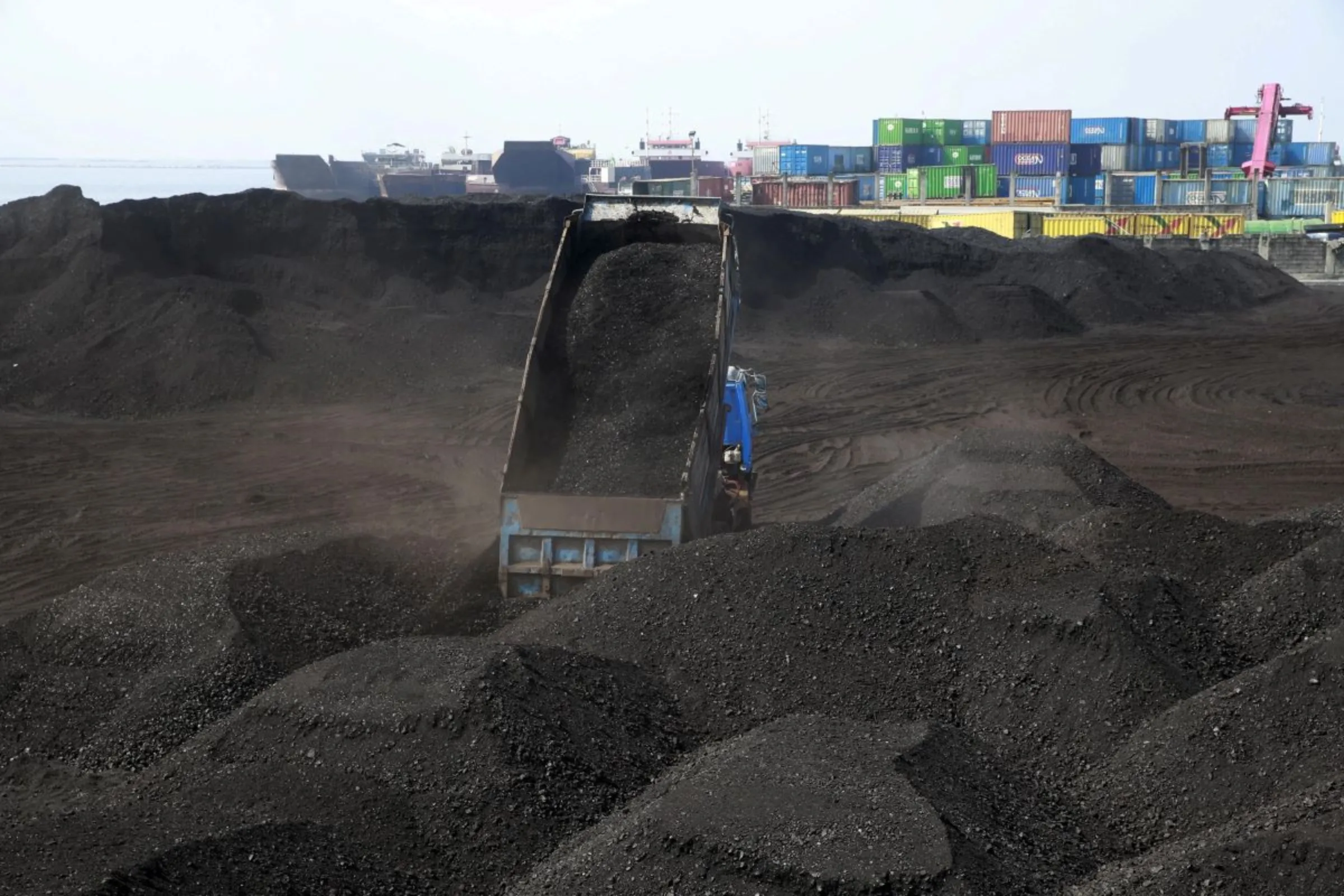 A truck unloads tonnes of coal inside a warehouse in Tondo city, metro Manila January 11, 2016