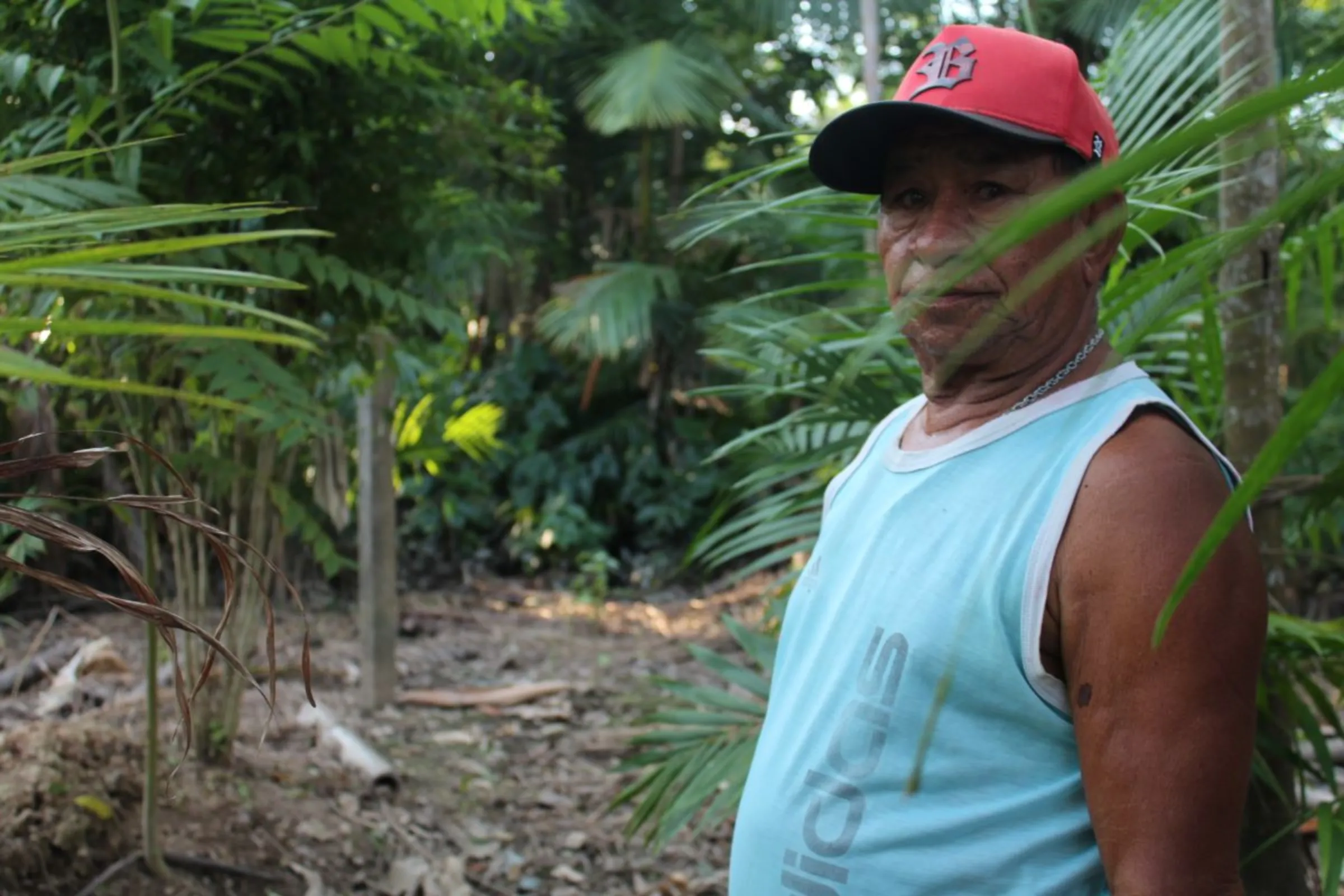 Retired fisherman João Assunção dos Santos shows a fence post erected near his home on Xingu Island, Brazil, which marks an area claimed by American grain trader Cargill. Photo taken on August 11, 2023. Thomson Reuters Foundation /André Cabette Fábio