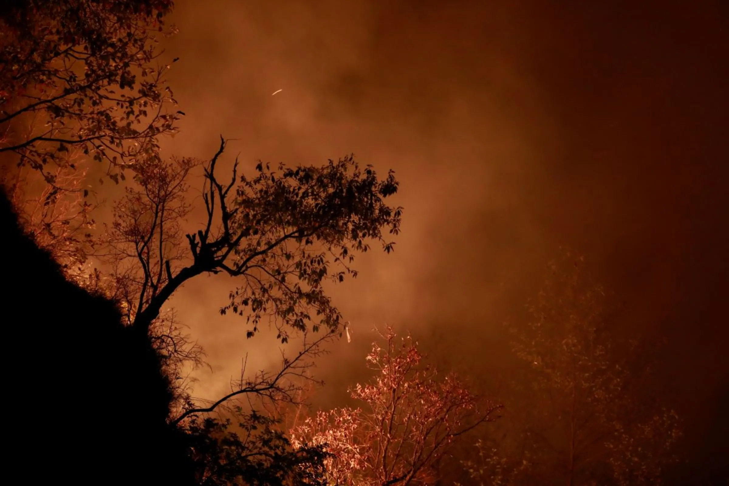 A portion of a hill burns during a forest fire in Makwanpur, outskirts of Kathmandu, Nepal April 8, 2021. REUTERS/Navesh Chitrakar